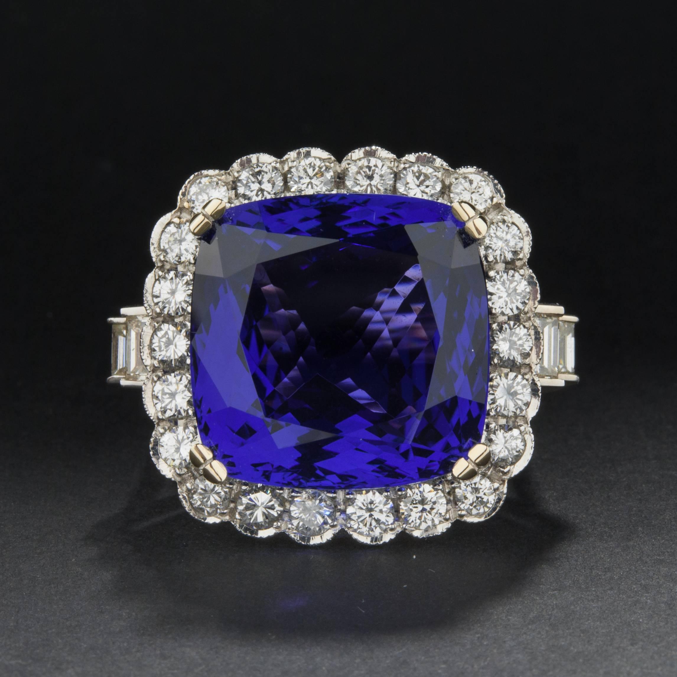 An absolutely stunning 24.59 carat tanzanite ring. The massive center stone is mouted in an 18k white gold setting and accented by approximately 2.00 total carats of diamonds. The ring is 23mm wide and it is currently size 7.