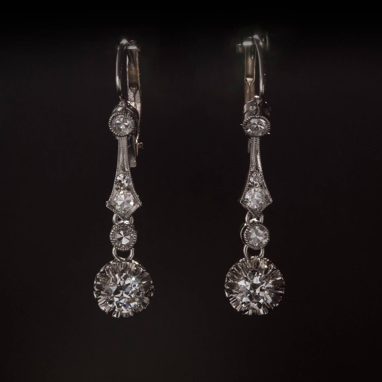 A stunning pair of diamond earrings crafted circa 1930. This piece is crafted in 14k white gold and features 2 larger diamonds for a total of .75 carats in addition to .40 total carats of accent diamonds. 
