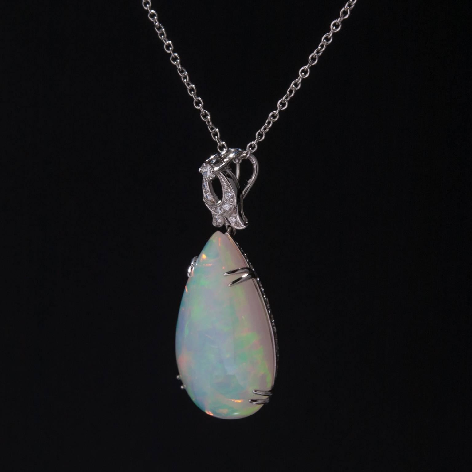 A stunning 21.38 carat Ethiopian Opal pendant with .19 total carats of accent diamonds. This substantial pear-shaped opal measures 30mm by 19mm and is set in 14k white gold.

Chain not included.