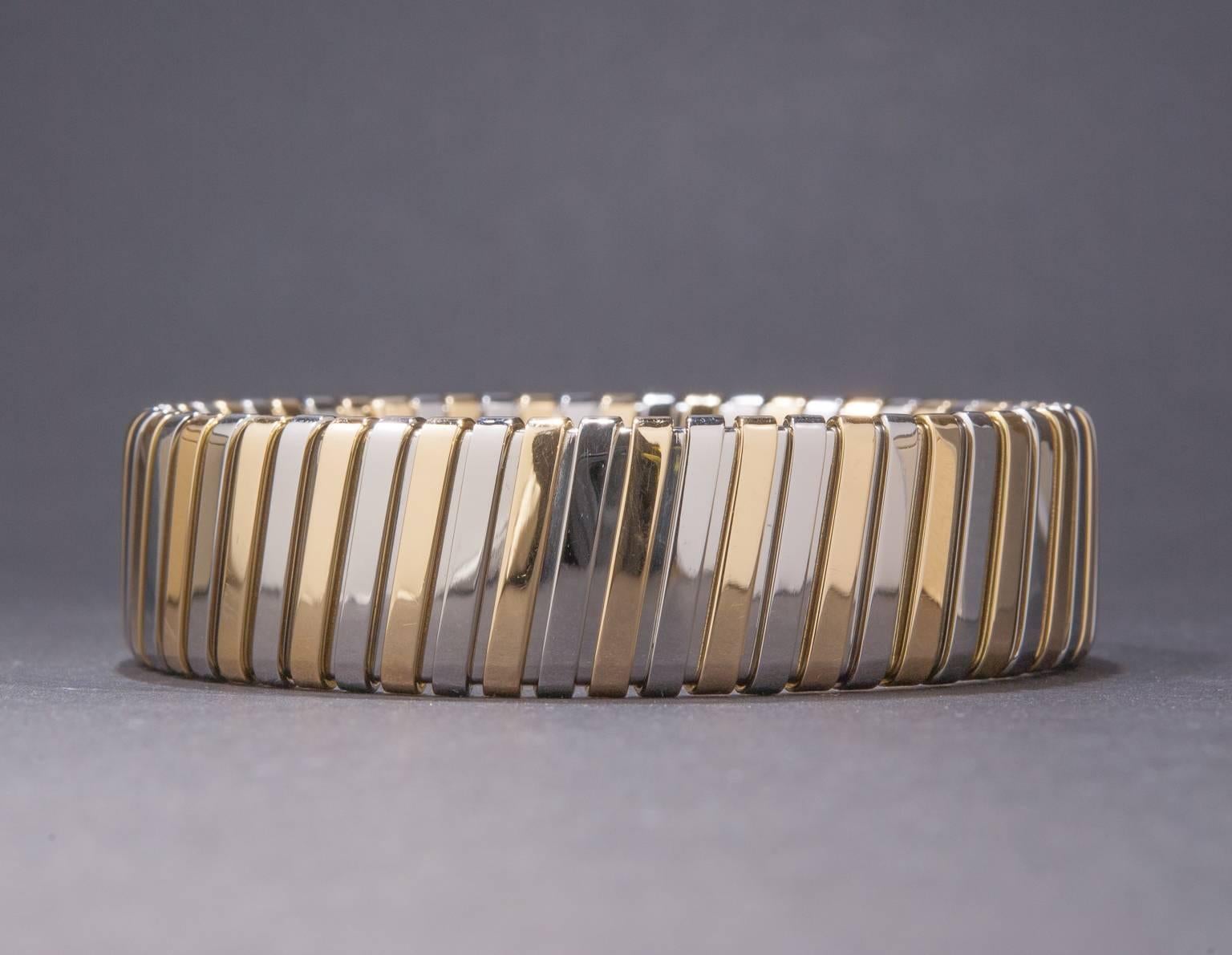 A stylish and attractive 18k two-tone gold bracelet designed by Bulgari. This Italian made piece has a flexible design that allows for a comfortable and secure fit on most wrist sizes. The bracelet measures approximately 15mm (slightly over 1/2
