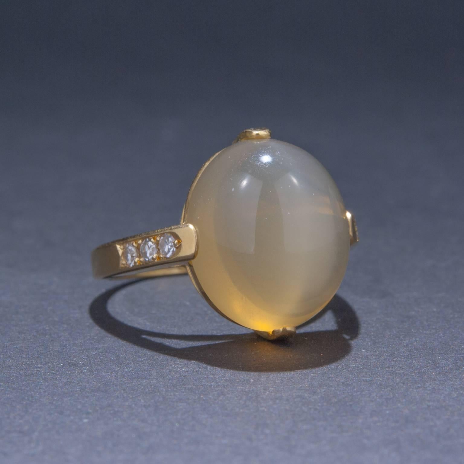 This lovely moonstone ring features 6 accent diamond for a total of .12 carats.  The ring is made in 18k yellow gold and is currently sized at 6  3/4.