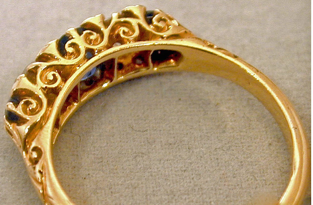 Sparkling Victorian five stone ring with three sapphires and two diamonds interspersed with eight small diamonds in an elaborate 18K yellow gold setting .  The ring is a size 7 1/2 and can be resized.