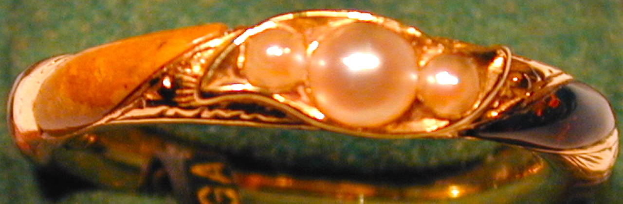 Unusual Victorian Scottish agate ring set with three natural pearls.  The engraved 15K gold setting has a variety of agates interspersed around the band. This beautiful and unusual ring is a size 6, its width is 3/16
