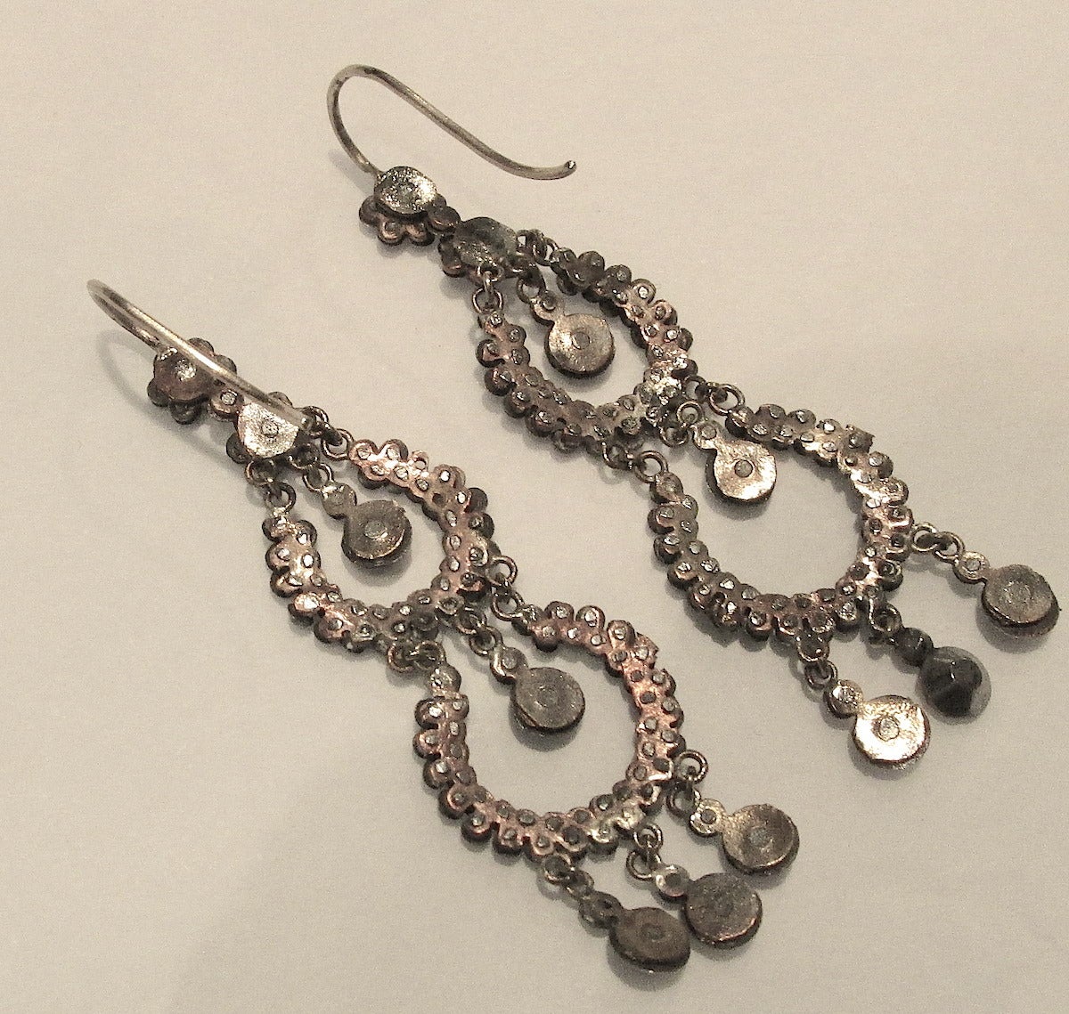 Sparkling Victorian cut steel earrings with two circles and five drops. Their movement will glitter and glisten with every movement. Fun to wear day or night.  The earrings measure 2" long and 5/8" at their widest. Cut steel jewelry is