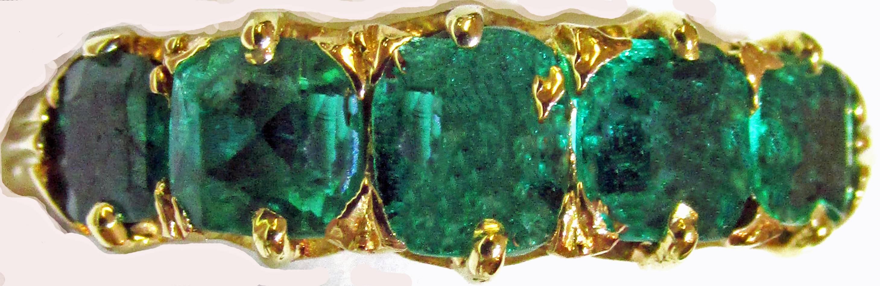 Classical early Victorian five stone emerald ring set in 18K gold, c1850.  Five stone rings were popular in the Victorian era.  Lovely to wear stacked with a gold band or other gemstone rings. The ring is a size 5 1/4.