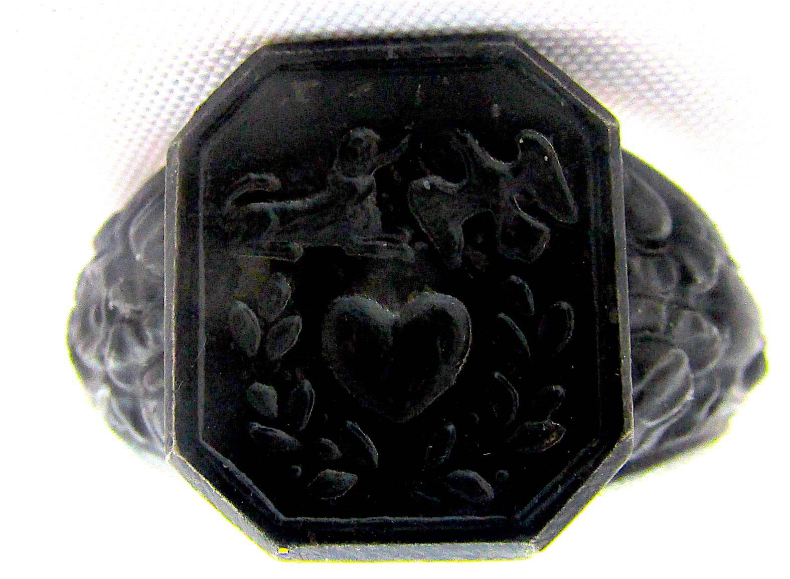 Fabulous Berlin iron ring decorated with symbols associated with faith (dove) love (heart) and loyalty (dog). The heart is surrounded by a leafy wreath and surmounted by the dog and the dove. The band has a floral motif, probably laurel leaves.