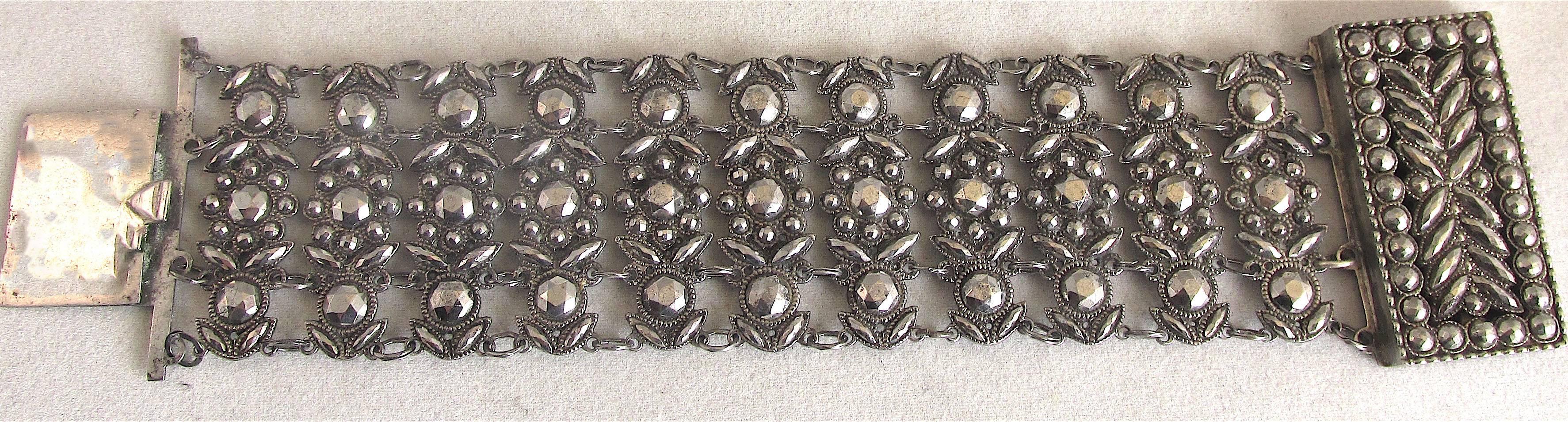 Georgian cut steel cuff bracelet dating to c.1800. Cut steel jewelry is made of tiny steel studs mounted into a base plate. It originated in the village of Woodstock in Oxfordshire. The studs were faceted to reflect light and give off a brilliance