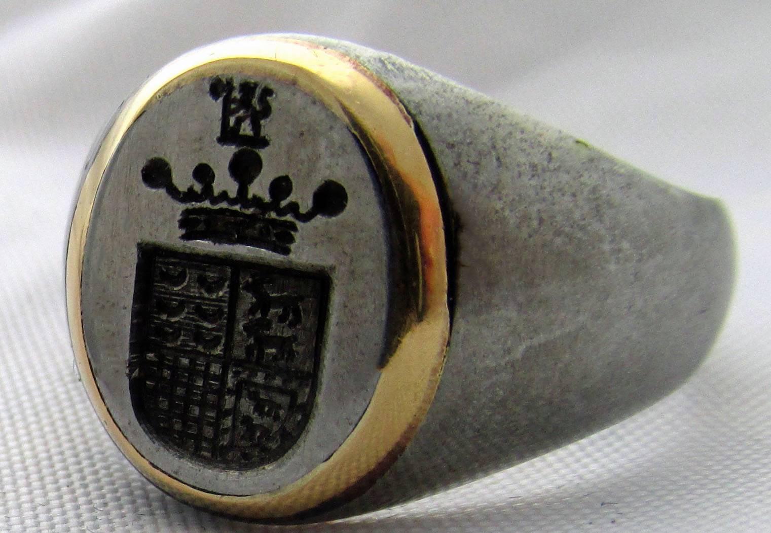 Bold and handsome Victorian signet ring of steel enhanced with gold. The crest on the Portuguese coat of arms is a crown implying nobility. These rings were originally used to officially mark a document. The ring is a size 9 1/2 and measures 9/16 at