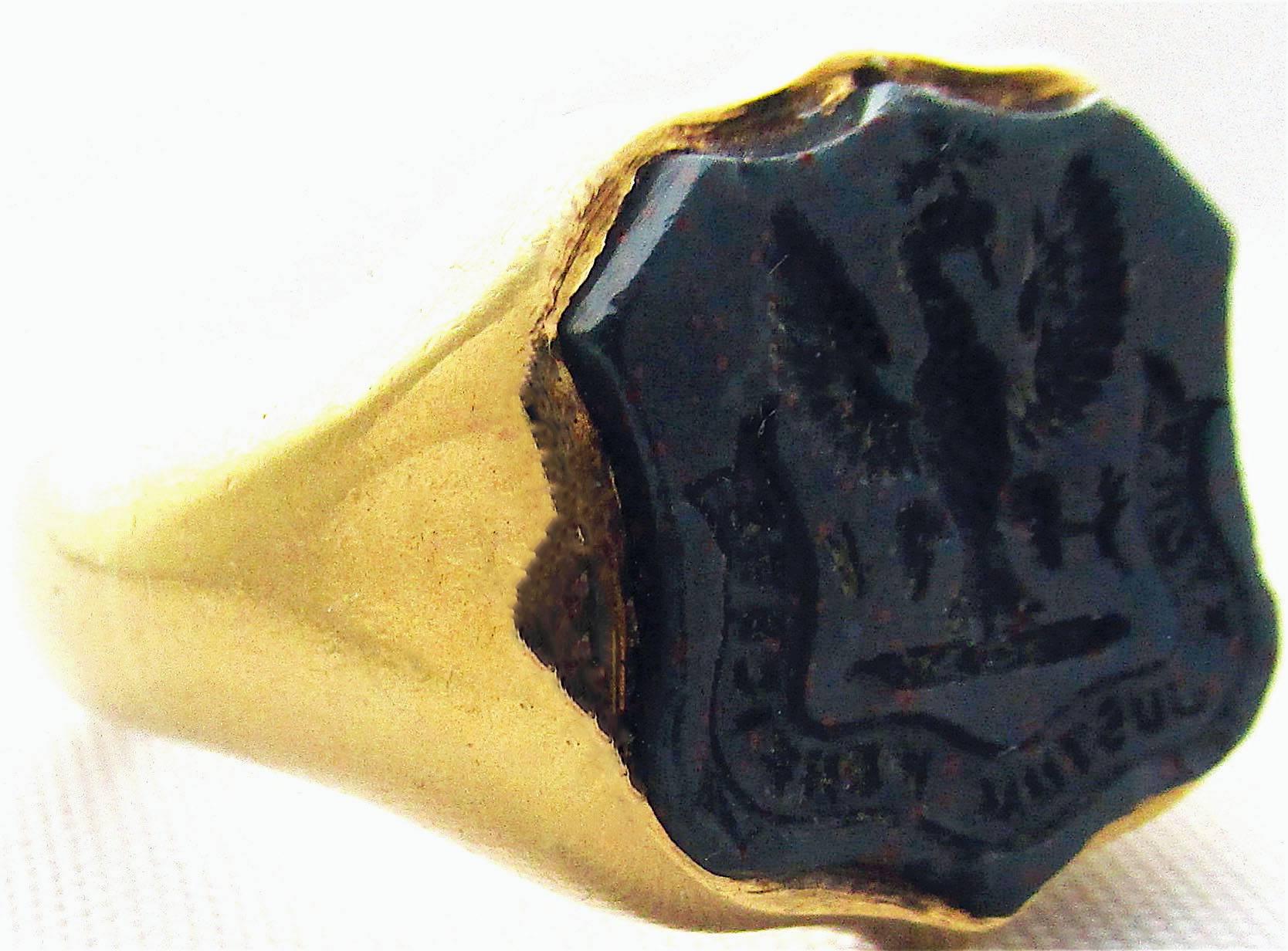 Handsome and bold 18K gold and bloodstone seal ring carved with an eagle crest. The ring is marked for Birmingham 1923, made during the reign of George V.  The ring is a size 6 3/4 and measures about 5/8