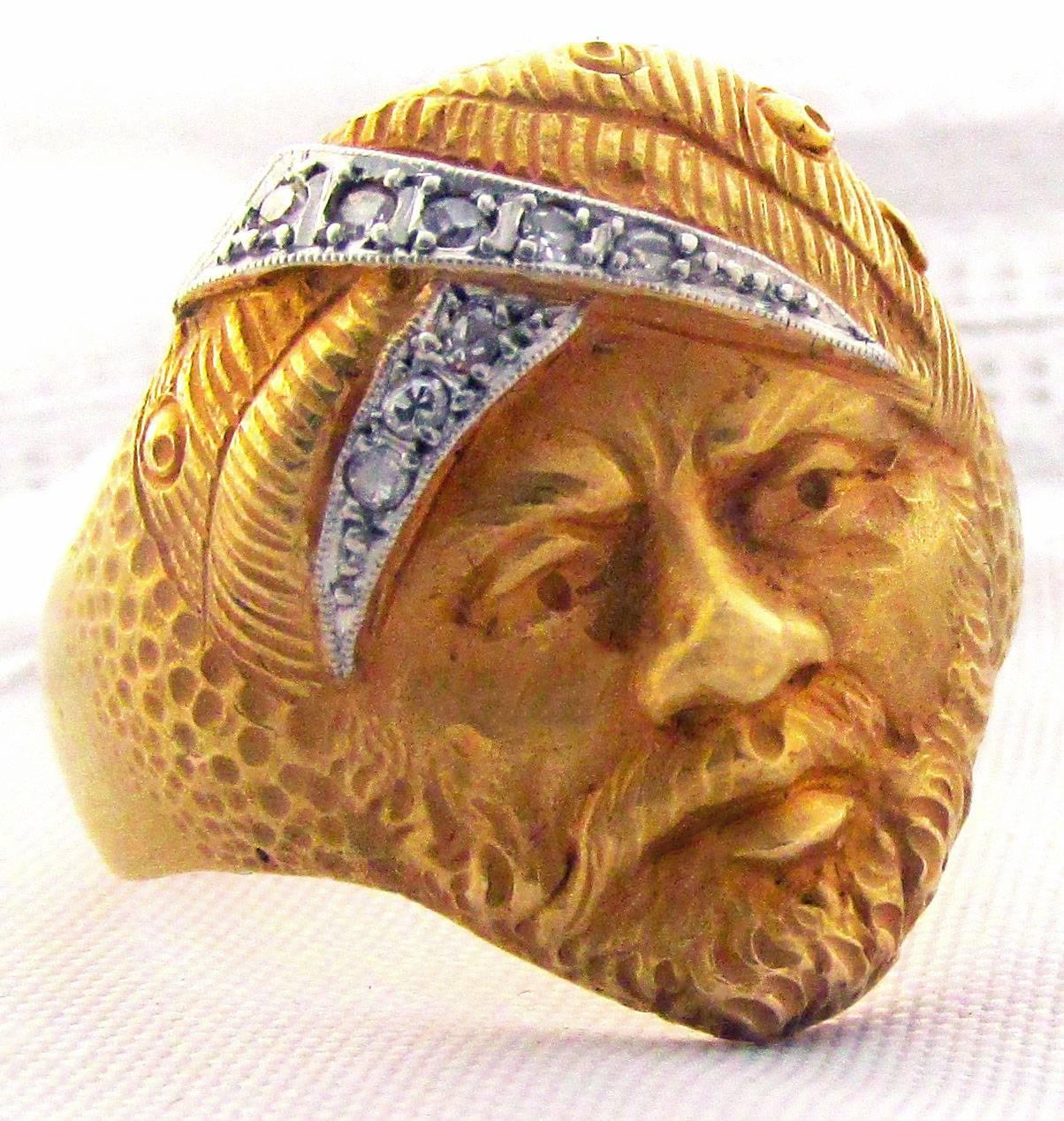 Striking early Edwardian 18K gold ring of a man in a turban set with diamonds.  The ring dates to 1900 . The ring has a French hallmark in the shape of a pineapple and a makers mark 