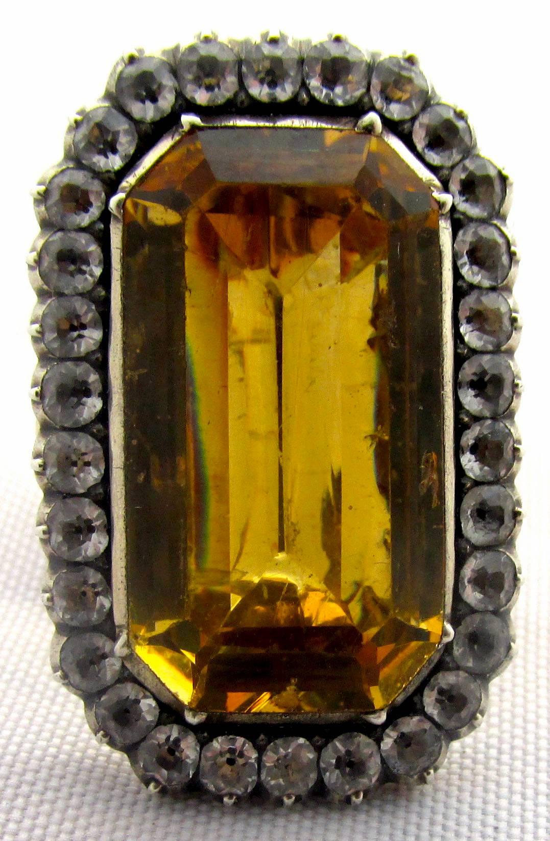 Brilliant Georgian clear and yellow paste ring set in 18K gold and silver. The yellow paste was meant to emulate citrine. This bold ring might have been worn by either a man or a woman probably during the seasons.  The English upper classes would