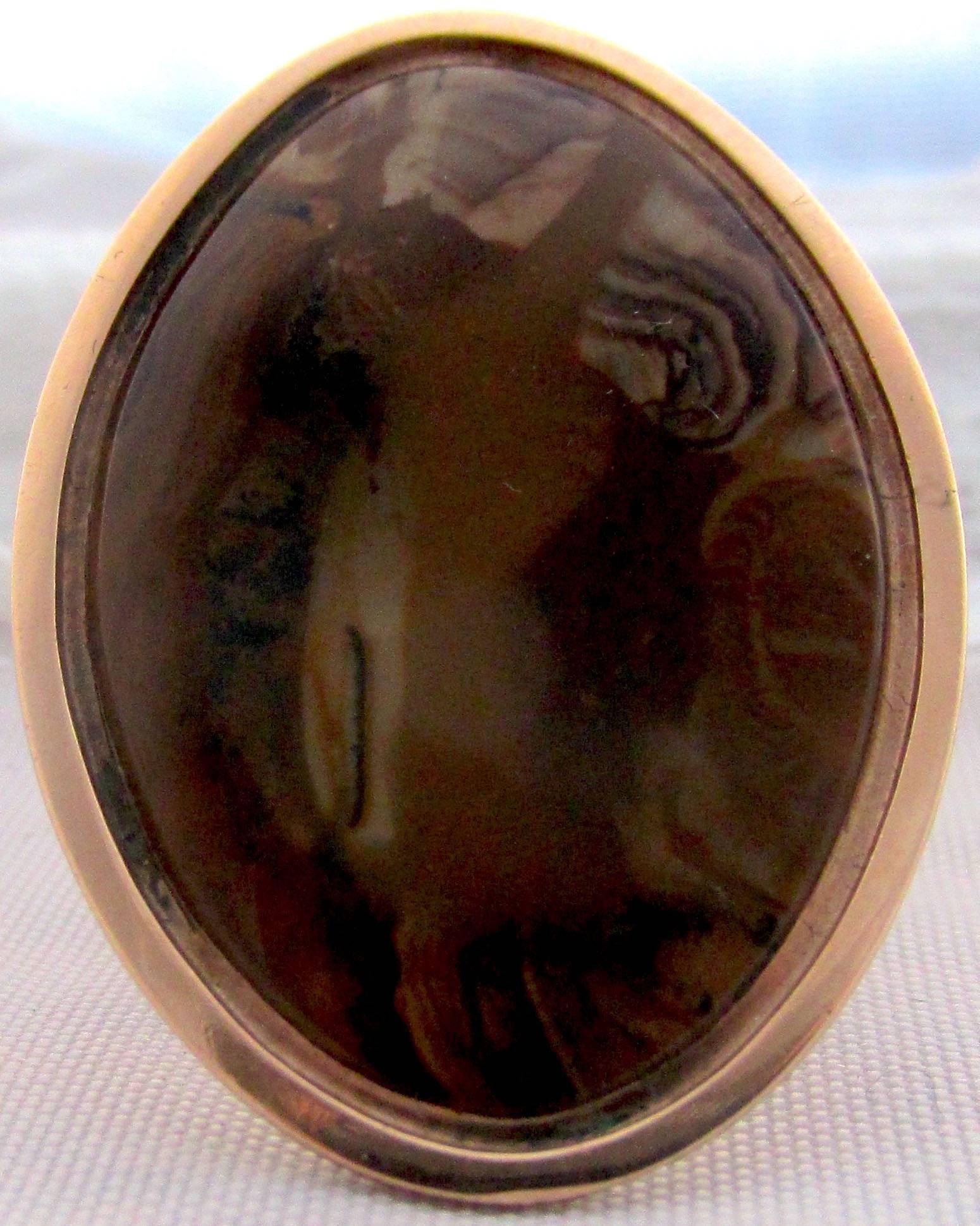 Dramatic Georgian 18K gold and agate navette shaped ring. The brown, black and tan colors swirl around the ring in a lively array. The surface of the ring measures 1