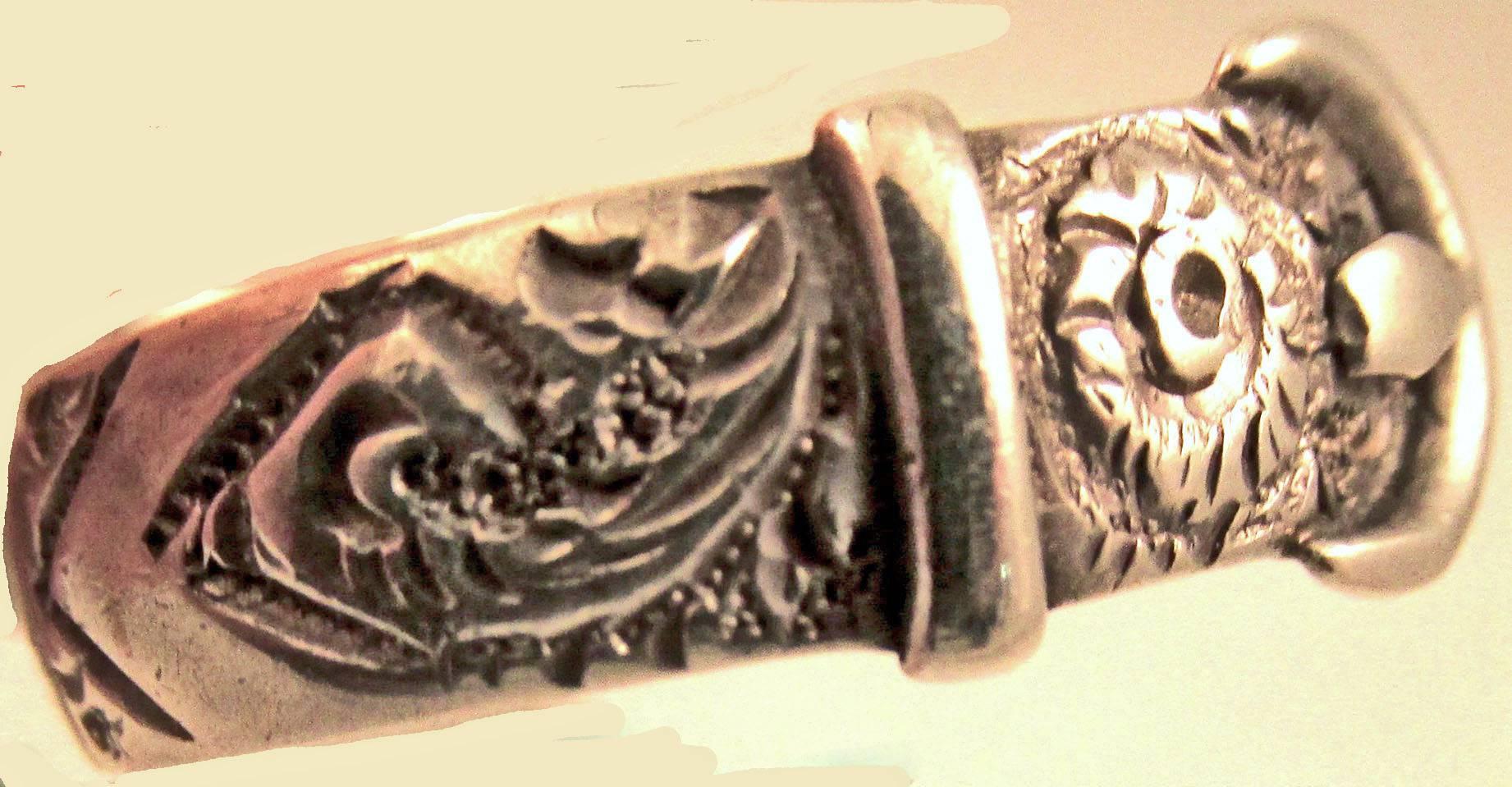 Wonderful Victorian buckle ring fully chased with a floral motif. Buckle jewelry became popular when Queen Victoria as a member of the order of the garter wore hers on her arm.  Buckle rings symbolize eternal love and friendship. This embossed