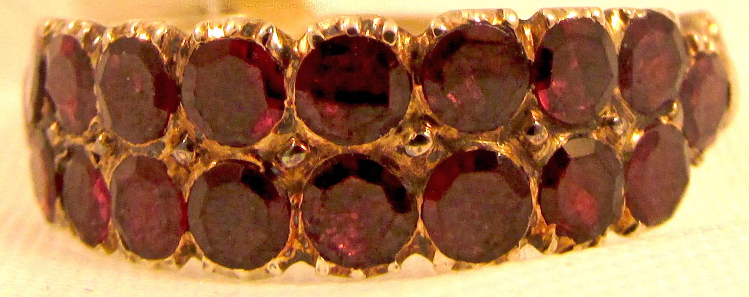 Wonderful Georgian almandine garnet ring in two rows and set in 18K gold with elaborately carved shanks. Great to wear alone or stacked with other rings. The ring is a size 8 and measures 1/4" at its widest, c1800 