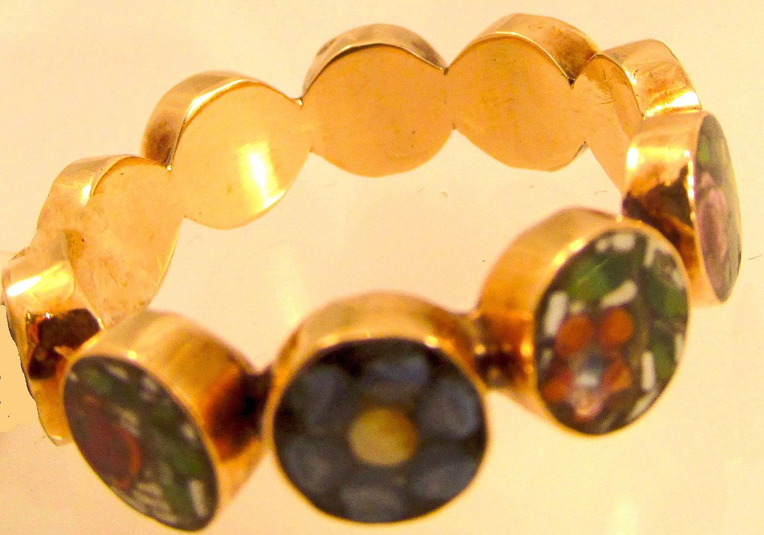 Unusual Georgian micro mosaic eternity band set with tesserae depicting flowers in 18K gold. Wearing micro mosaic jewelry became popular during the Grand Tour period as the small size of the micro mosaic was appealing and could be worn on the