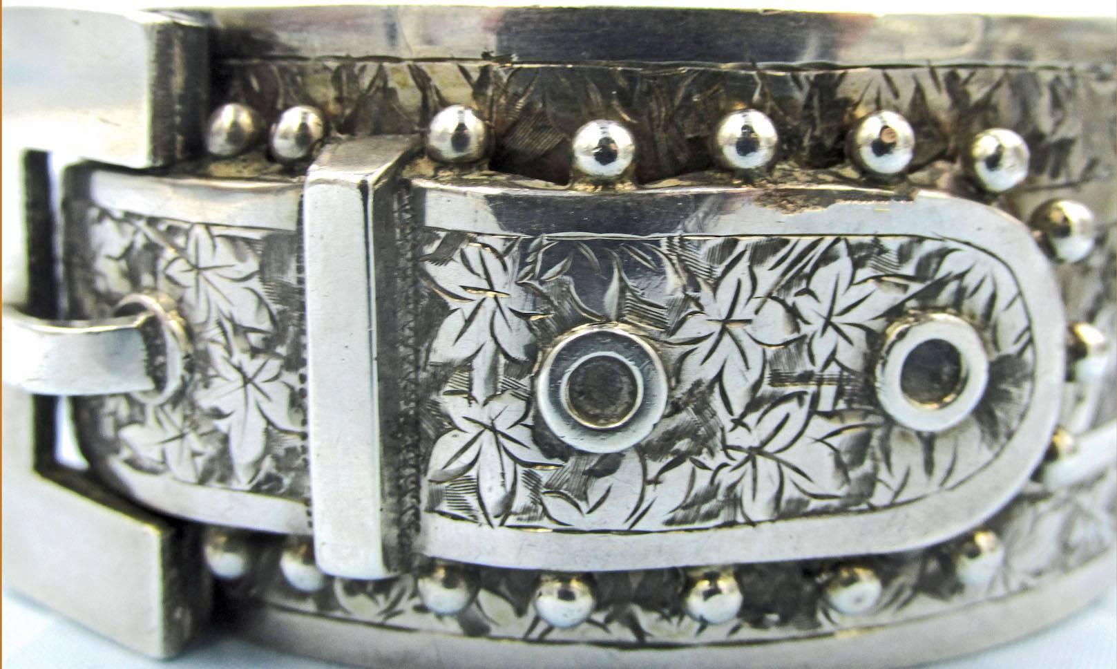 Bold and dramatic Victorian buckle bracelet engraved with ivy leaves and decorated with beads. Lovely to wear alone or with other bangles, either silver or gold. This piece measures 1 1/4