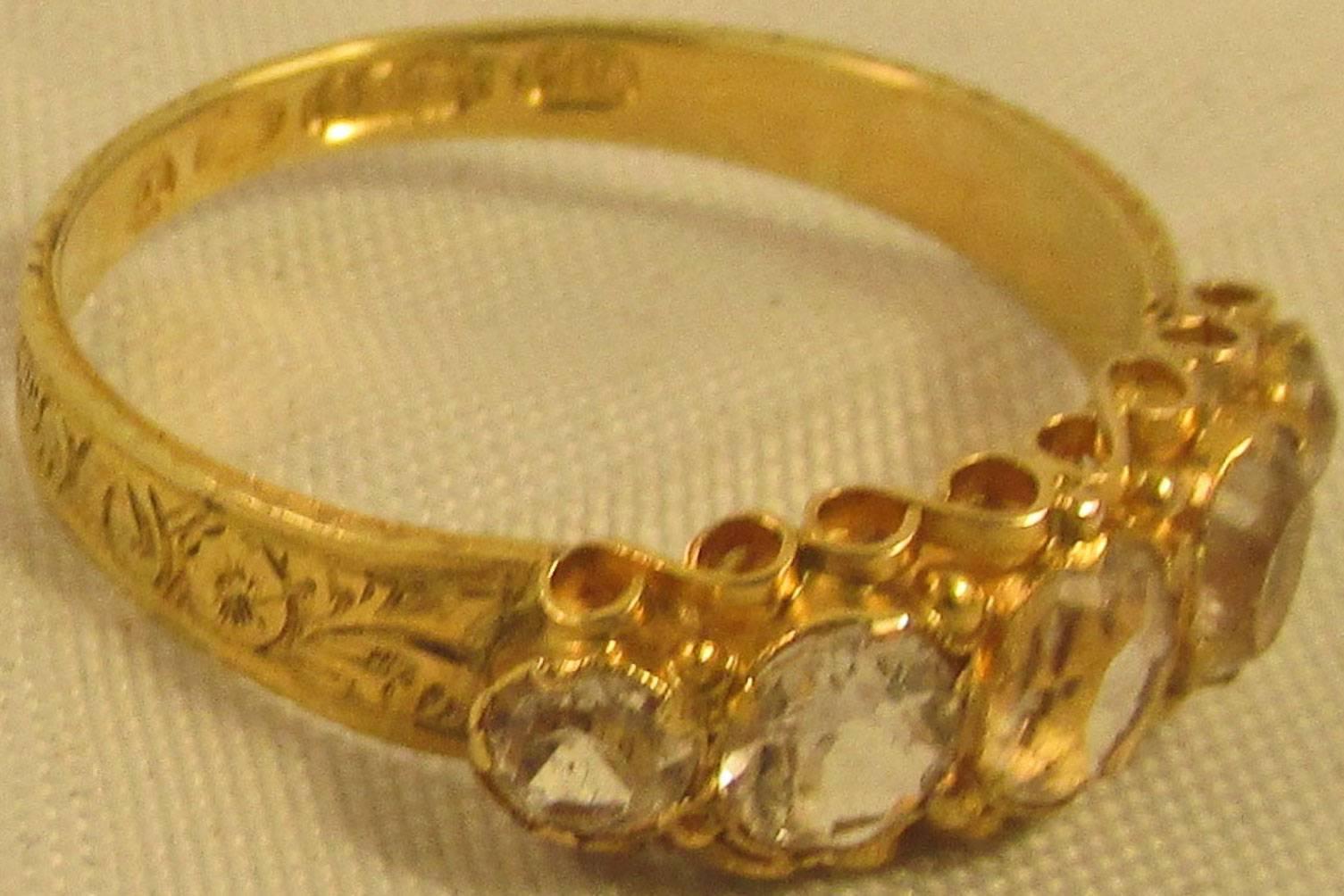 Wonderful Victorian 18K five stone diamond ring hallmarked Birmingham, C1880. The elaborate setting is enhanced by an ornately carved gold shank. Beautiful to wear alone or stacked with other rings. It is a size 6.5.    