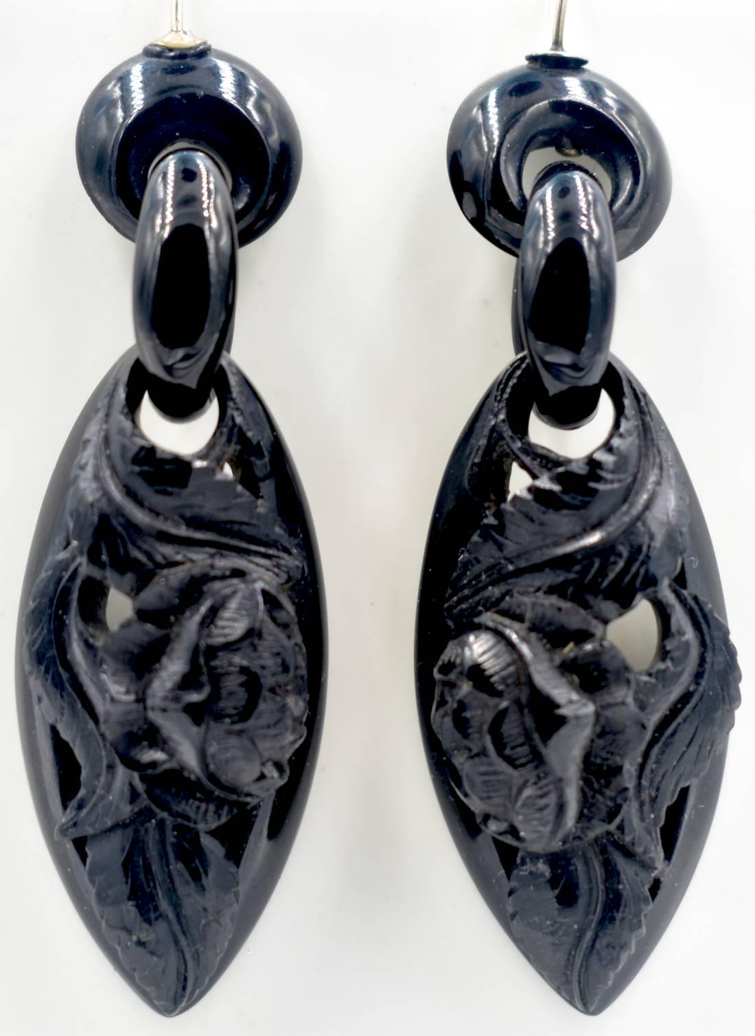 Striking Victorian Whitby jet earrings with a floral design. Jet jewelry became popular after the death of Prince Albert in 1861 when the court went into official mourning. These striking earrings measure 2 1/2" long and 3/4" at their