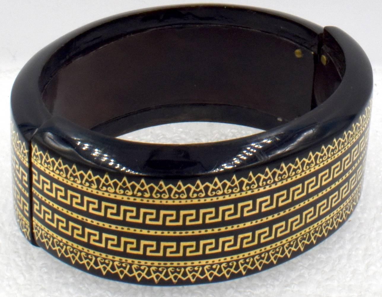 Victorian pique cuff bracelet with a Greek key design. This wonderful bangle expands for easy put on and off. The gold inlay is crisp and smart looking. The bangle measures one inch wide and the interior dimensions are 1 7/8
