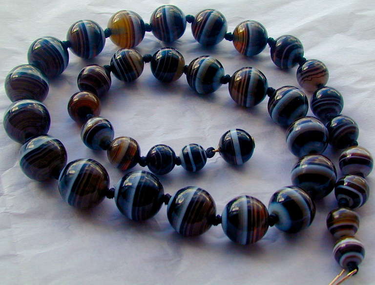 Lovely long strand of black, brown and white agate beads with a bead clasp. The necklace measures 22 1/2