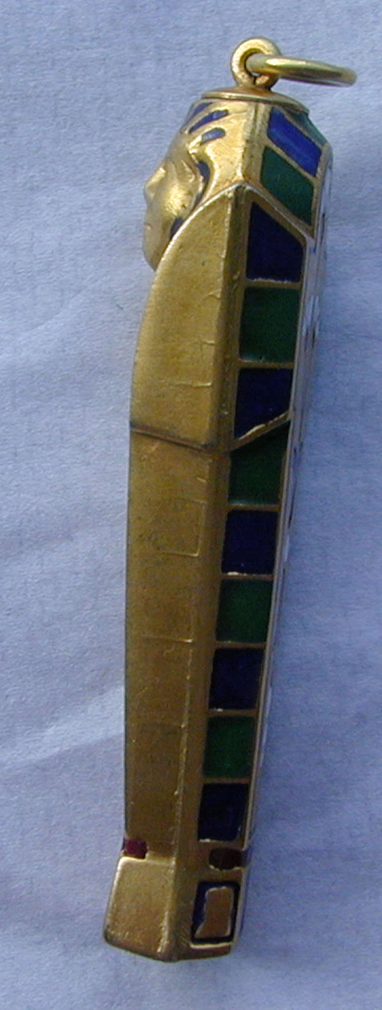 Victorian Egyptian Revival pencil in an unusually large size makes it fantastic to wear as a pendant. Decorated in gilt metal and enamel in bright colors it will draw the eye to its wonderful design. The pencil measures 2 3/4