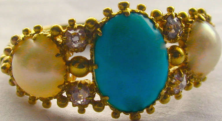 Georgian turquoise, pearl and diamond ring set in cannetille work 15K gold which is known for its intricate bead and wire designs. The ring is a size 5 3/4 and measures 3/8