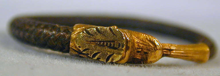 Georgian 15K two-color gold and hair snake ring. The image of a snake with its tail in its mouth goes back to Egypt in the 14th century BC and has remained ever since as a symbol of eternity, everlasting life and eternal love. In Victorian England