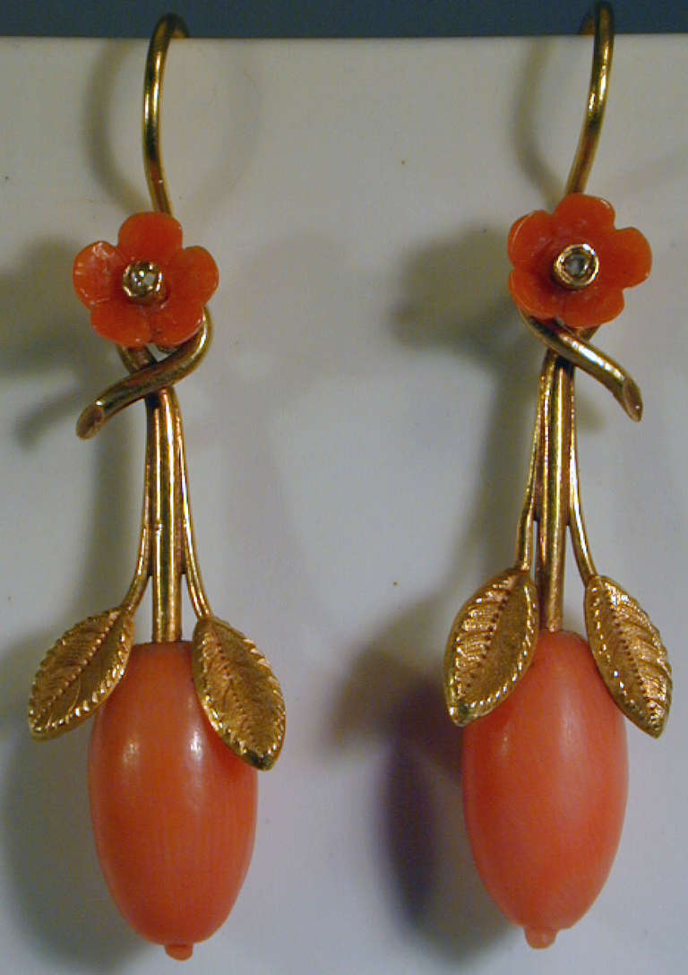 Delightful Victorian earrings in 15K gold with coral in a rose and rose hip design.  Rose hips are the fruit of the rose plant. The earrings are  1 3/4" long and 1/2" at their widest.