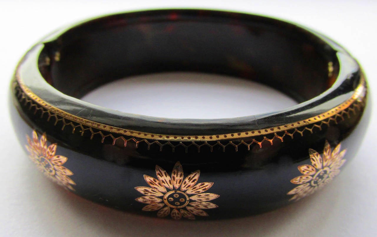 Delightful Victorian pique bangle bracelet. Pique is tortoiseshell inlaid with gold and silver. The technique was called pricking, in French piquer, to prick. Hence the name pique.  Floral and geometric designs were popular in the late 1800's. The