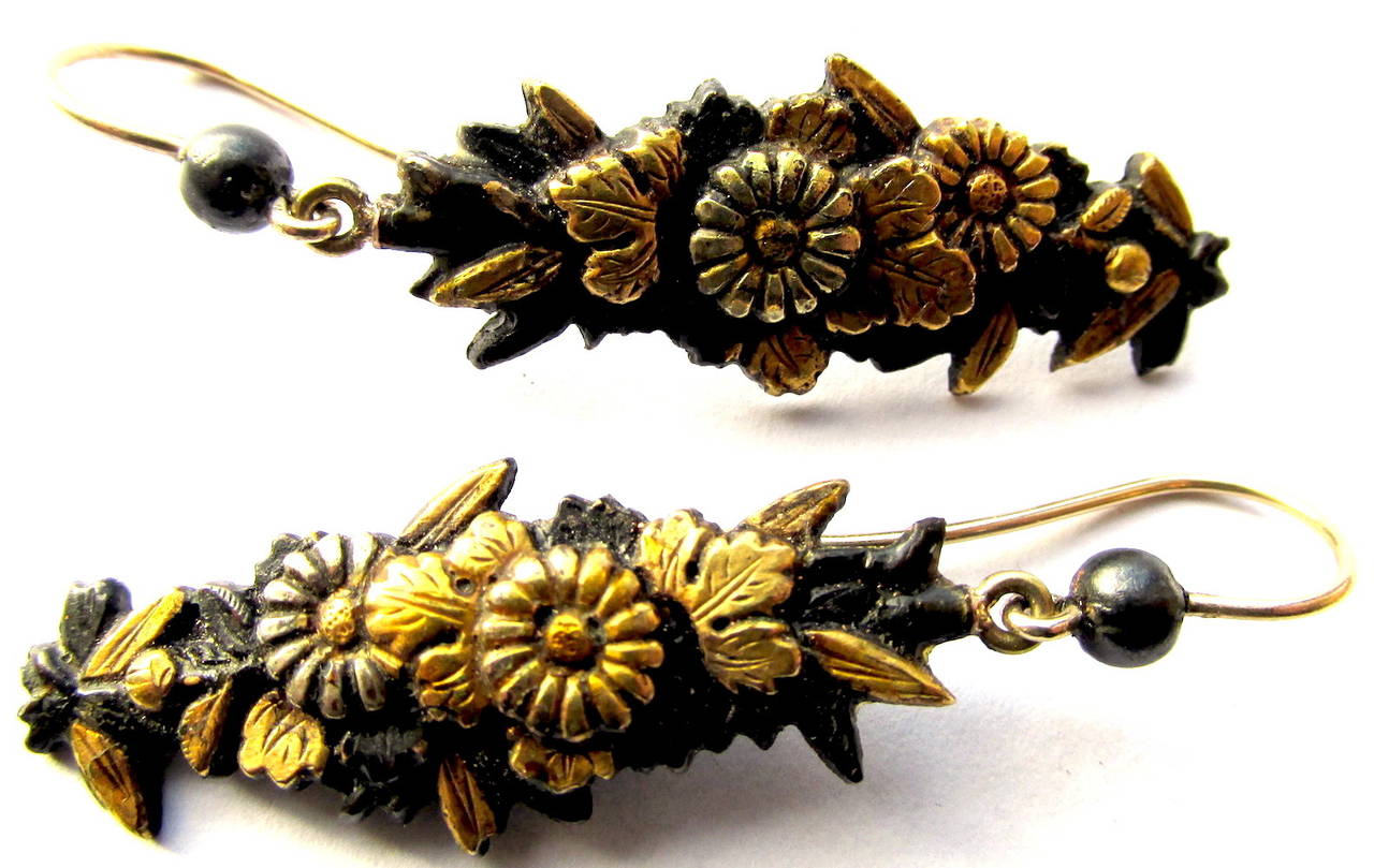 Delightful Japanese Shakudo drop earrings with a floral and leaf design. a The high gold content in Shakudo objects when treated with copper forms an indigo/black patina resembling lacquer.  Historically Shakudō was used in Japan to construct or