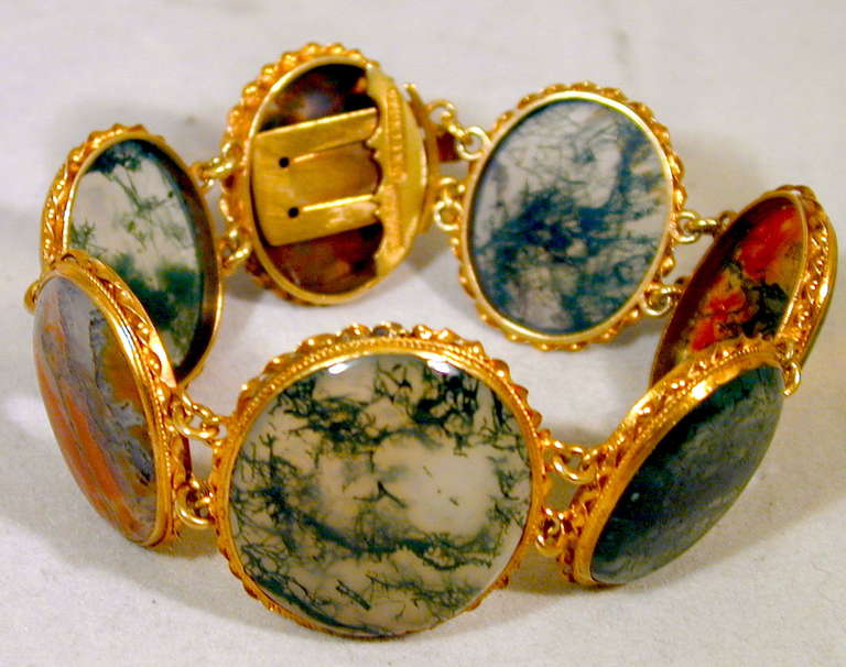 Lovely Victorian moss agate bracelet set in ornate gilded silver bezels which are marked sterling.  The swirling colors and multiplicity of forms in the stones create a feeling of dynamism and energy. A wonderful addition to a jewelry collection.
