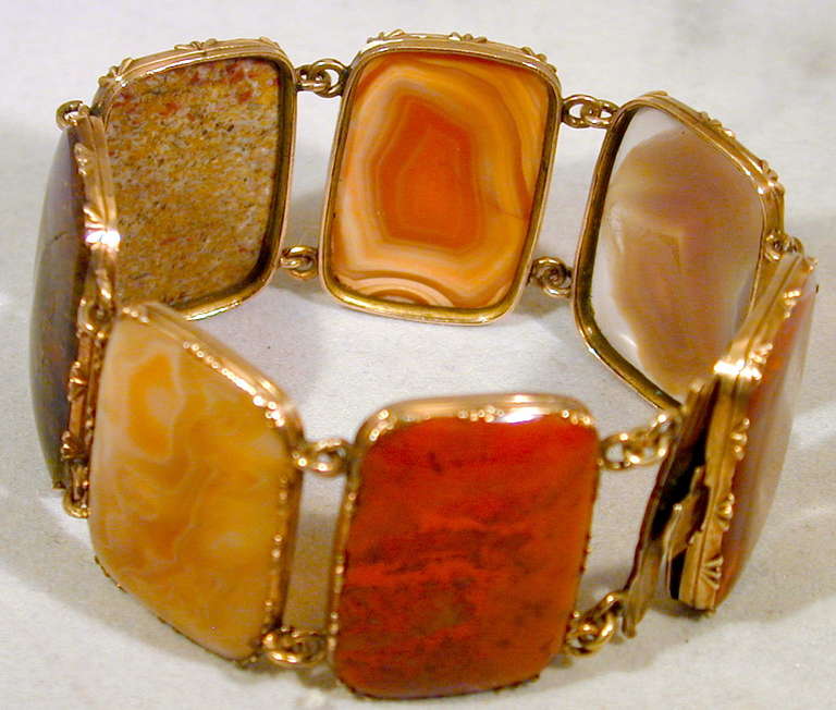 Georgian agate bracelet of various colors and patterns makes a wonderful and wearable piece of jewelry.  Turn it around and have a different  view to suit your attire.  The agates are set in 9K yellow gold and the bracelet measures 6 1/4" long.