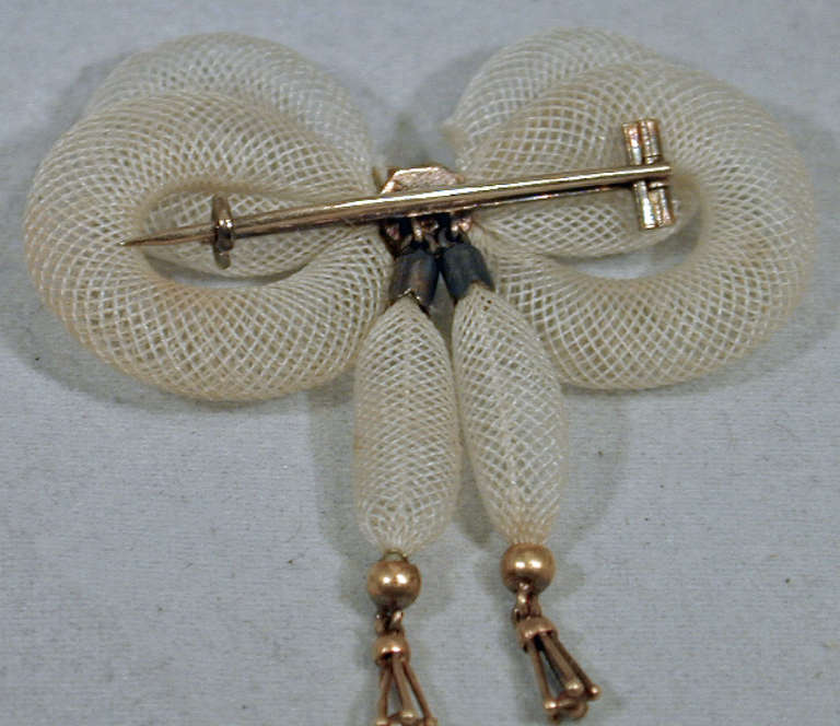 Lovely early Victorian bow pin of white woven hair set with turquoise in 15K gold. Hair jewelry was primarily of a romantic or loving nature. Queen Victoria was given a brooch made from her mother's hair for her 16th birthday.  This pin measures 1