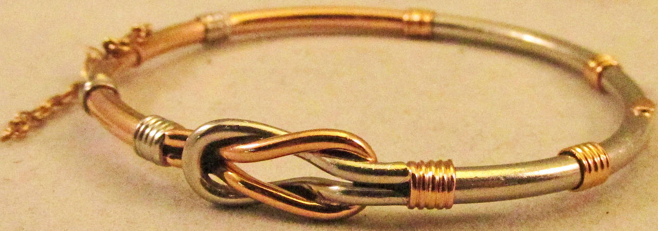 Delightful Edwardian bangle bracelet of platinum and 15K gold entwined around each other. Perhaps it was a lover's gift symbolizing the intertwining of two souls. The bracelet's interior measures 2 1/8