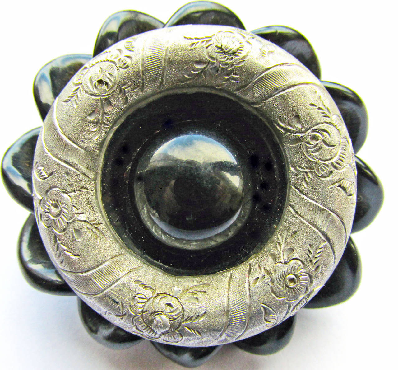 Striking Victorian Whitby jet and aluminium pin. This unique piece combines two of its period's most interesting materials. Whitby jet is a natural substance that is mined and then hand carved into jewelry and other objects. Aluminum was first made