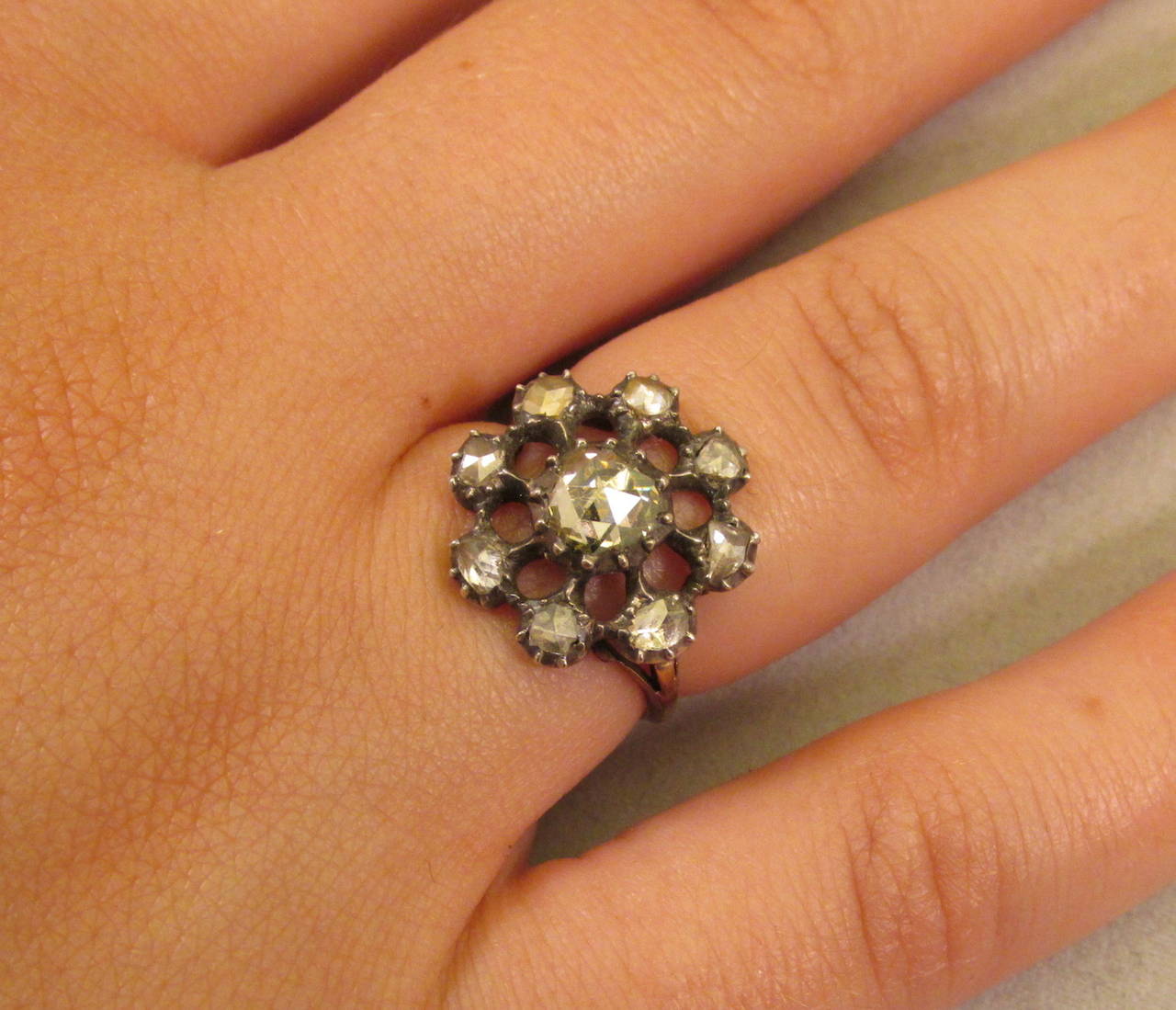 Dramatic Georgian rose diamond cluster ring set in silver with an 18K gold band. The center stone is a large Dutch crown rose diamond. The cluster ring head is almost .75 inches in diameter, large and imposing. The ring is size 6 1/4 and can be