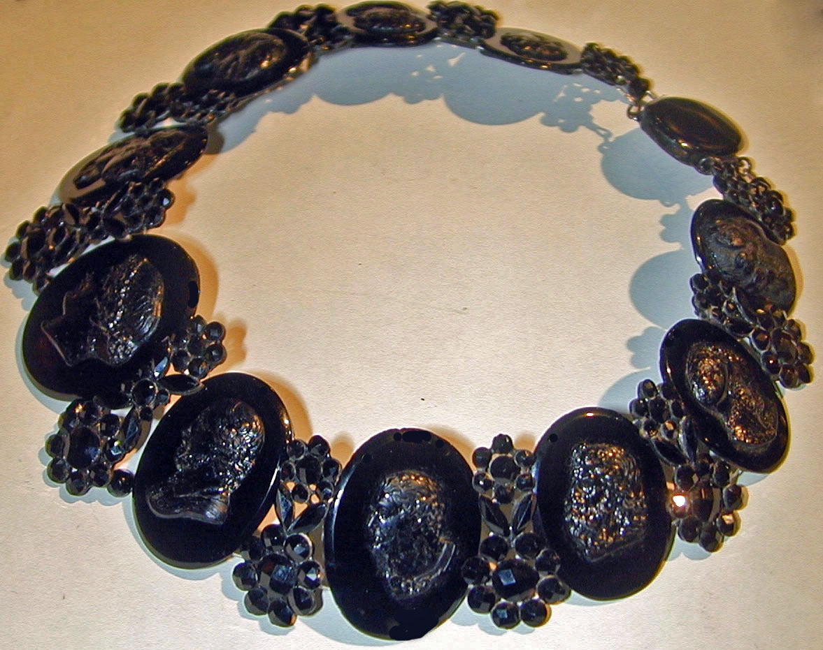 Fantastic Georgian cameo necklace or collar of French jet. The cameos of classical portraits are interspersed with flowers and leaves. This stunning and  unique necklace measures 13 3/4' long by 1 1/2