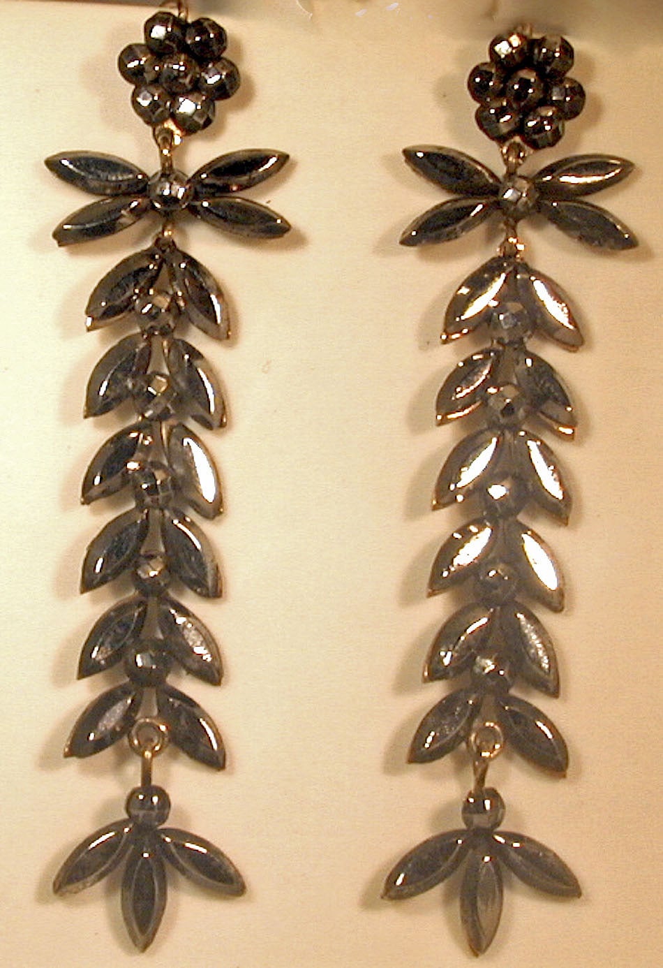 Victorian cut steel earrings of a foliate design with floral tops are wonderful to wear day or night. In its day cut steel Ijewelry was popular for evening wear as the faceted steel sparkled like diamonds in candlelight. The earrings measure 2 3/4