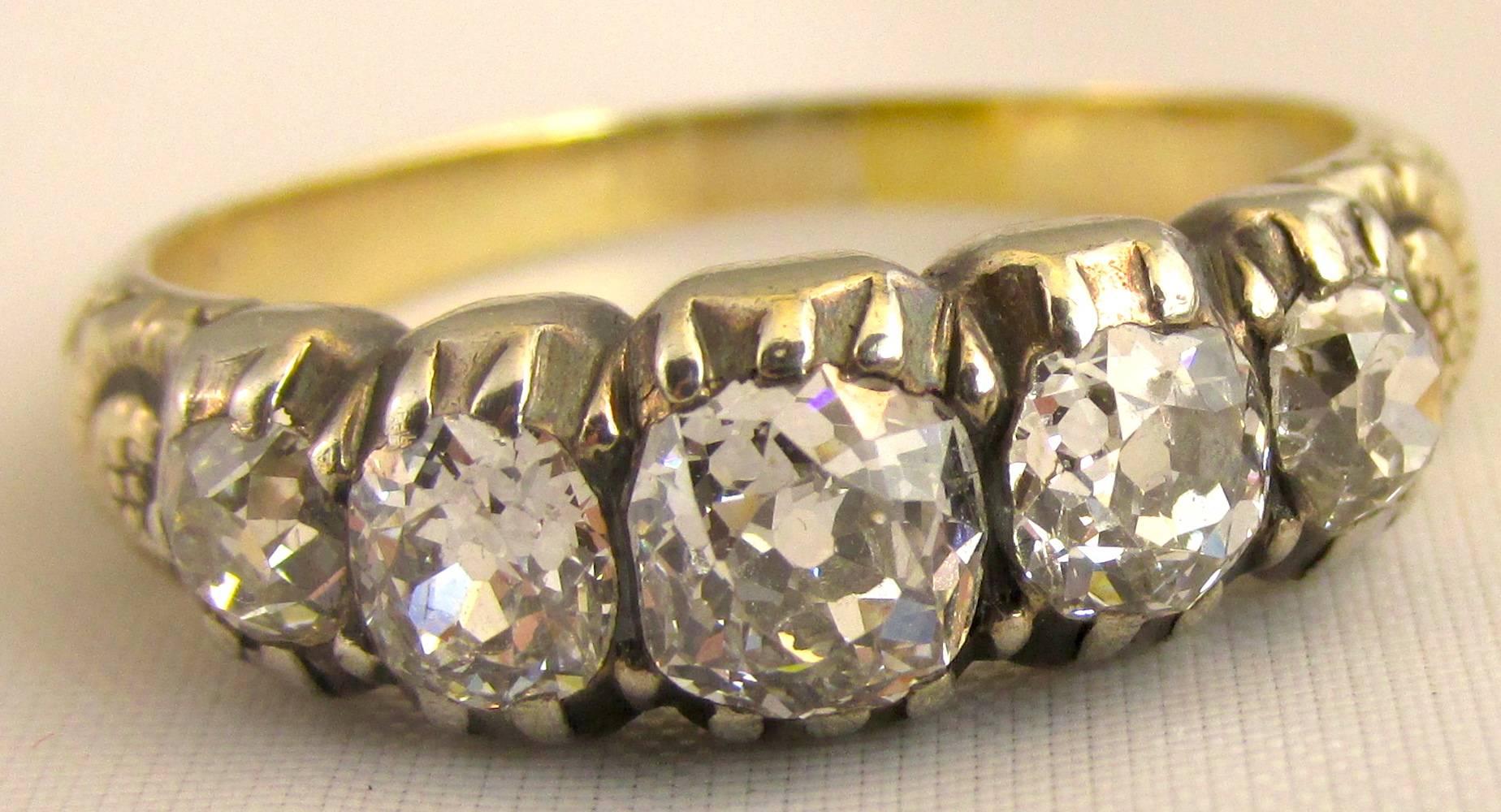 Exquisite early Victorian five stone cushion cut diamond ring set in a chased 18K gold band. Wonderful to wear with a wedding band or other 5 stone rings. The ring is a size 7.25.