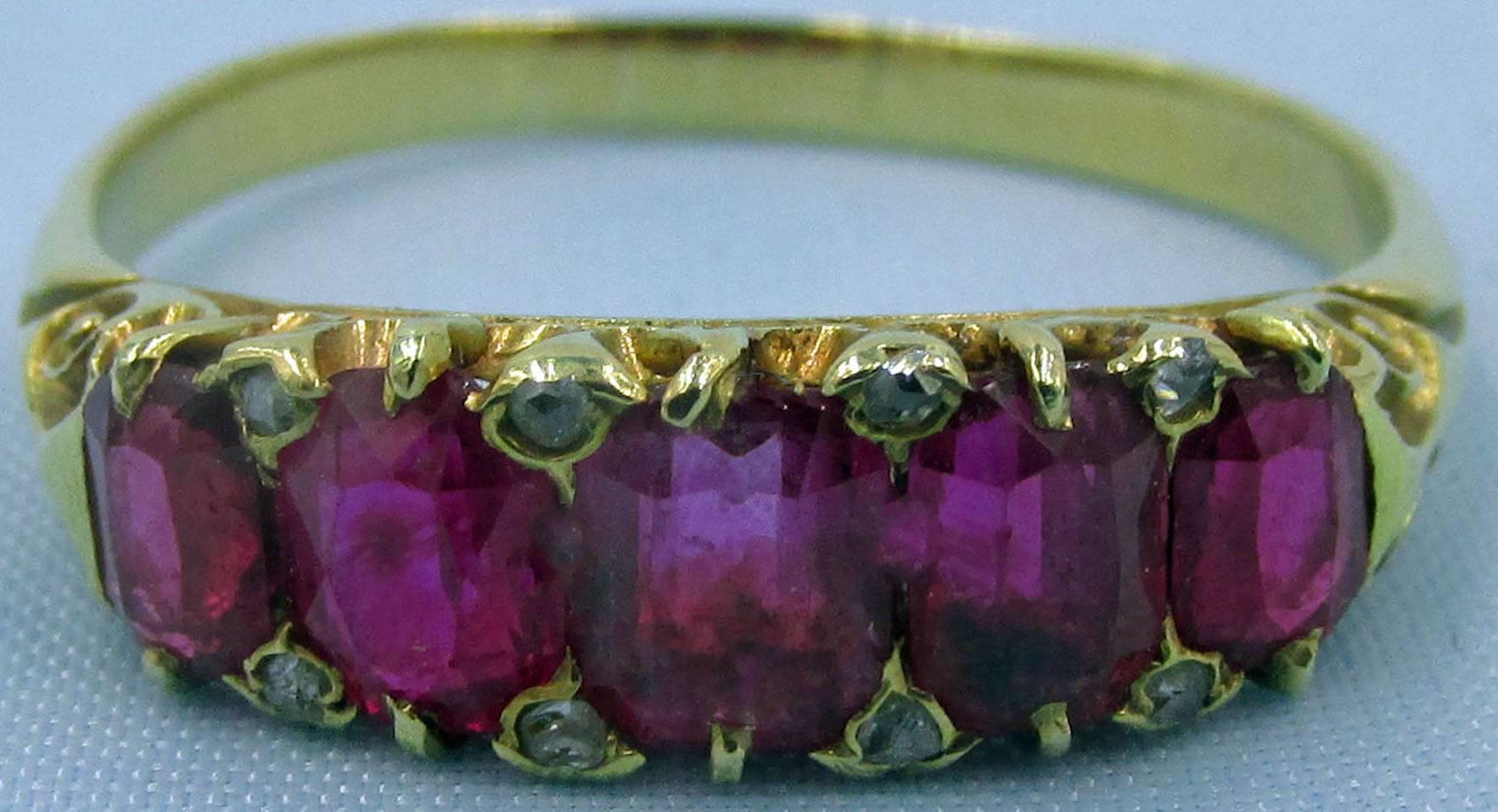 Exceptional antique  ring;  It is English,  Victorian,  set with 5 natural,  Cushion Cut, Burmese Rubies equalling an approximate 2 1/2 Carats of deeply saturated and light-catching brilliance in a beautiful hand carved unmarked yellow Gold claw