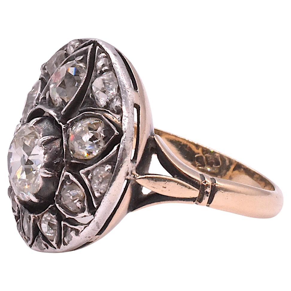 This unusual mid nineteenth century Gold and Silver Diamond Cluster ring is a variation of the classic Victorian cluster ring with a twist. The twist is that the the flower cluster is actually set in a mount of silver,  with pear shaped diamonds set