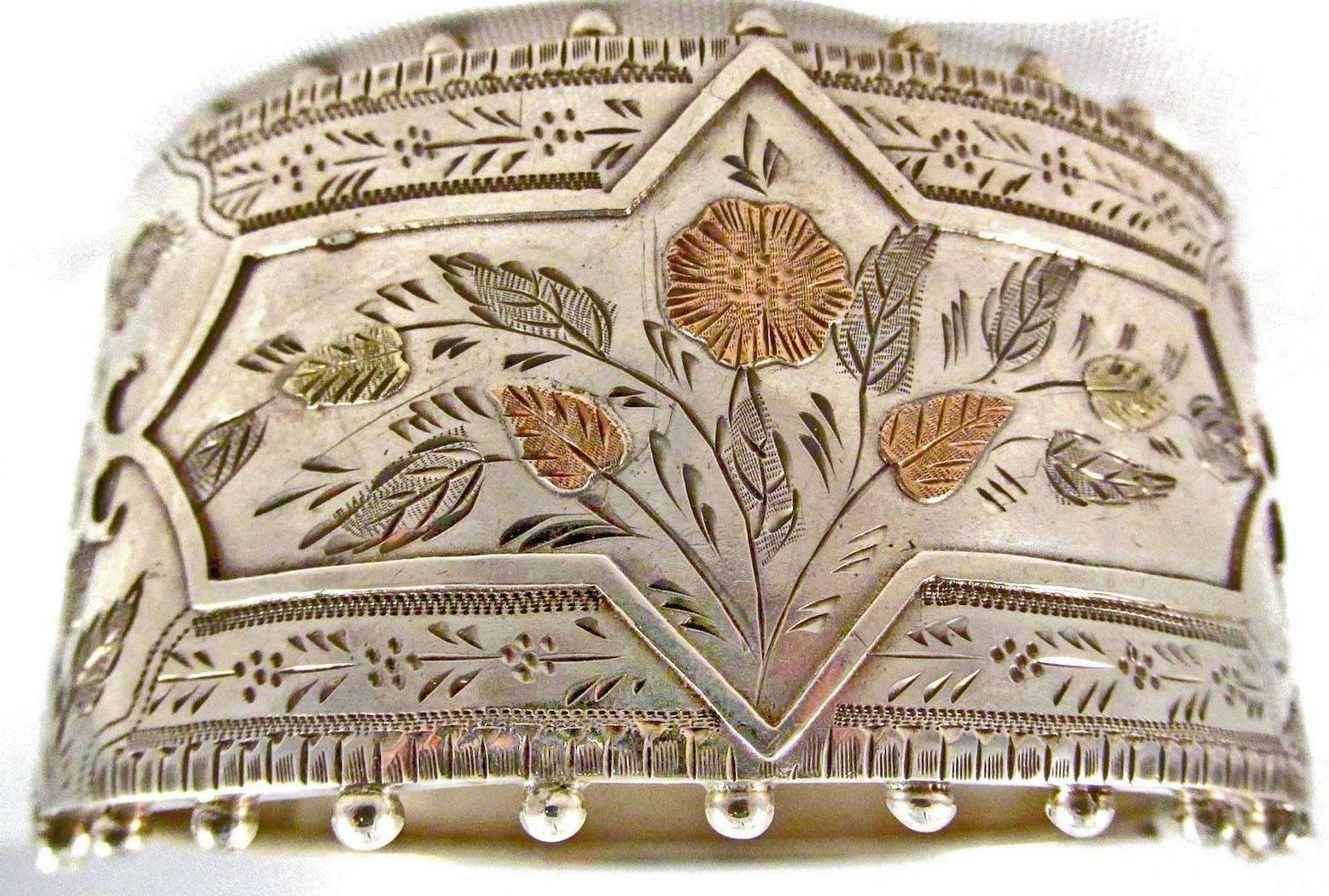 Victorian silver and two-color gold cuff or bangle bracelet. Wearable day or night this bracelet is decorated with beading on its rims. Its interior measurement is 2