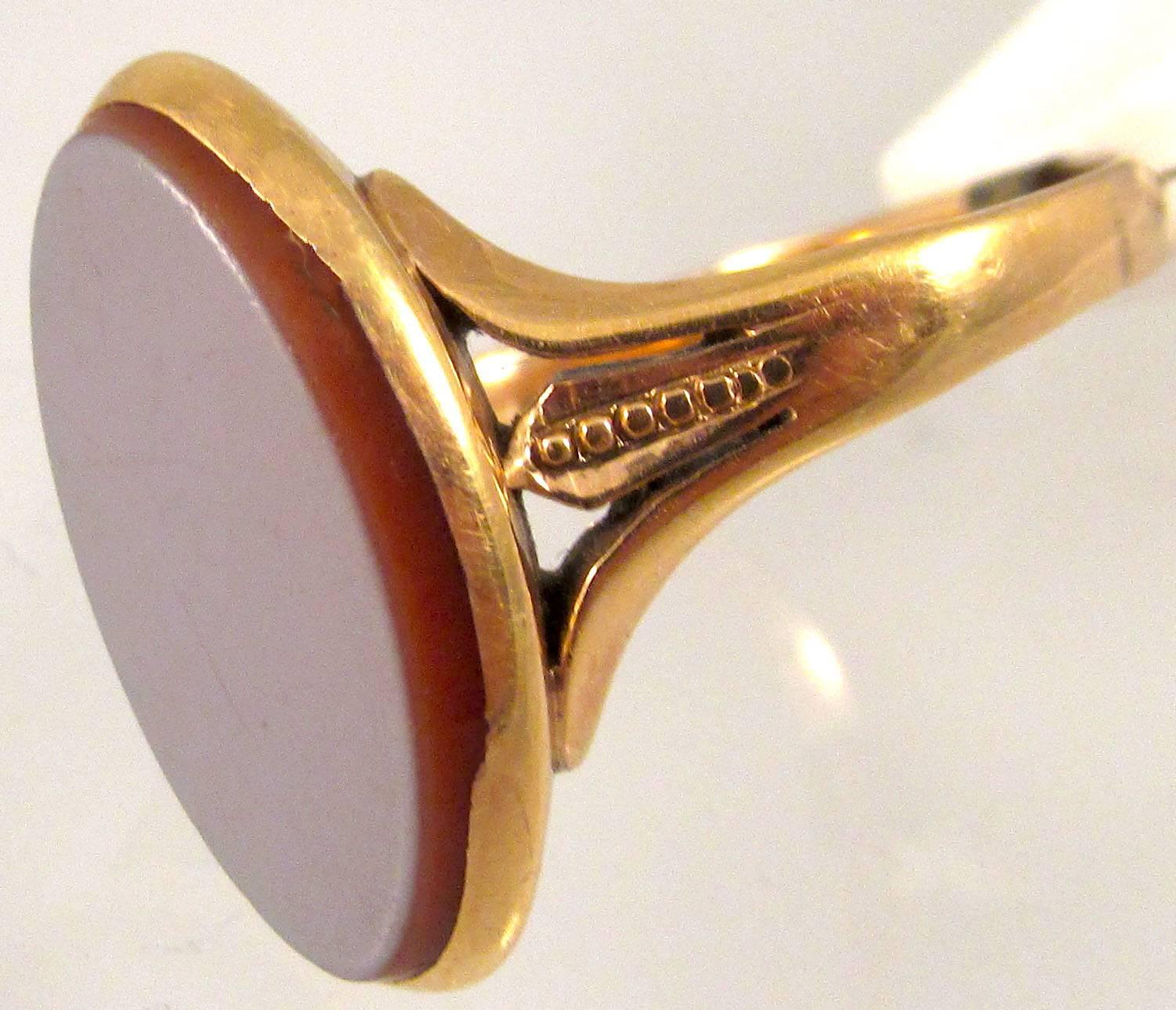 Lovely Victorian sardonyx ring set in 14K gold with a beaded flank. Sardonyx is a type of banded agate made of chalcedony with reddish and white layers. It is also the birthstone for August. The ring is a size 7 1/2 and the stone measures