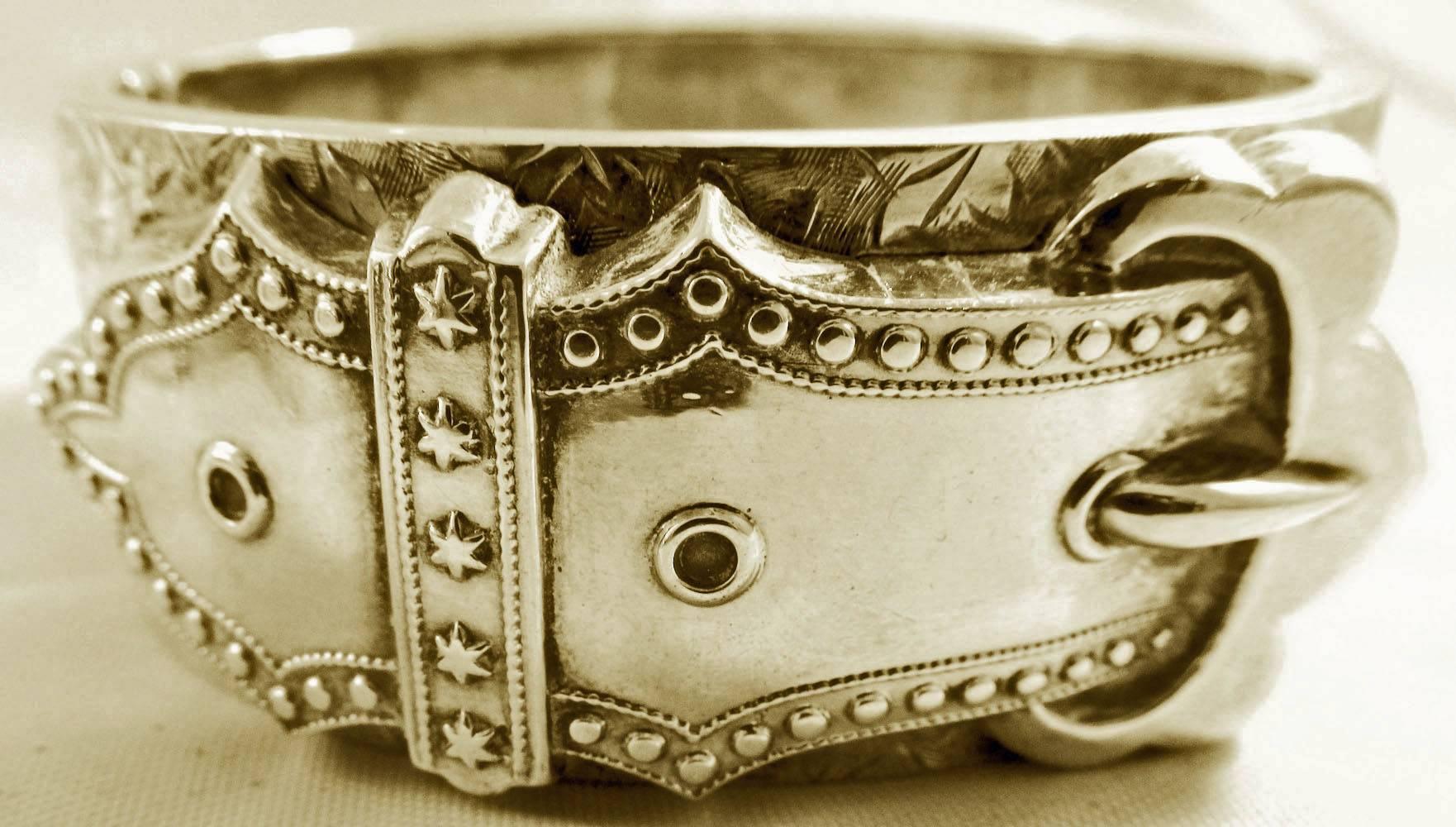 Wonderful Victorian buckle bracelet in sterling silver engraved with ivy leaves and decorated with stars and beads. The bangle is hallmarked for Birmingham in 1884 and measures 1" wide.  The interiors measurements are 1 15/16"by 
2