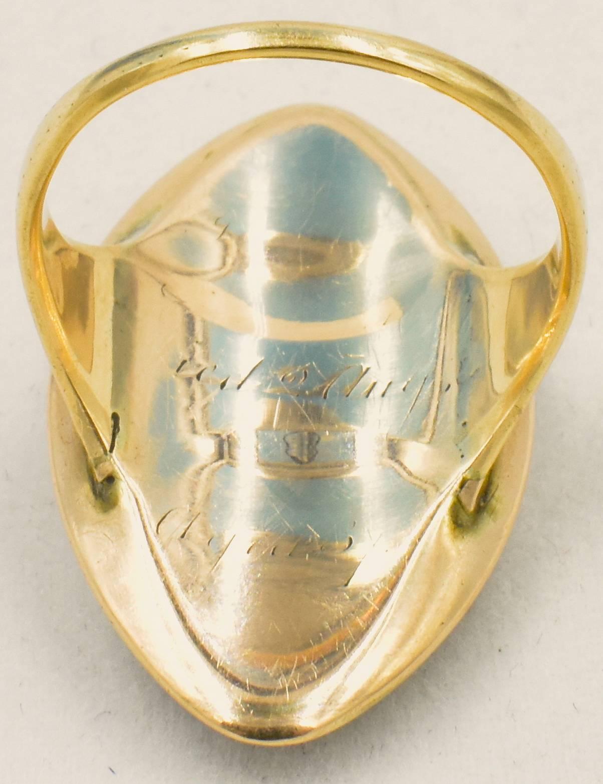An unusual Georgian navette shaped ring that is a combination of a love ring and a mourning ring, mounted in 15K ring with a plaque of royal blue guilloche enamel surmounted with old cut diamonds set in a floral and leaf rosebud design. The shank of