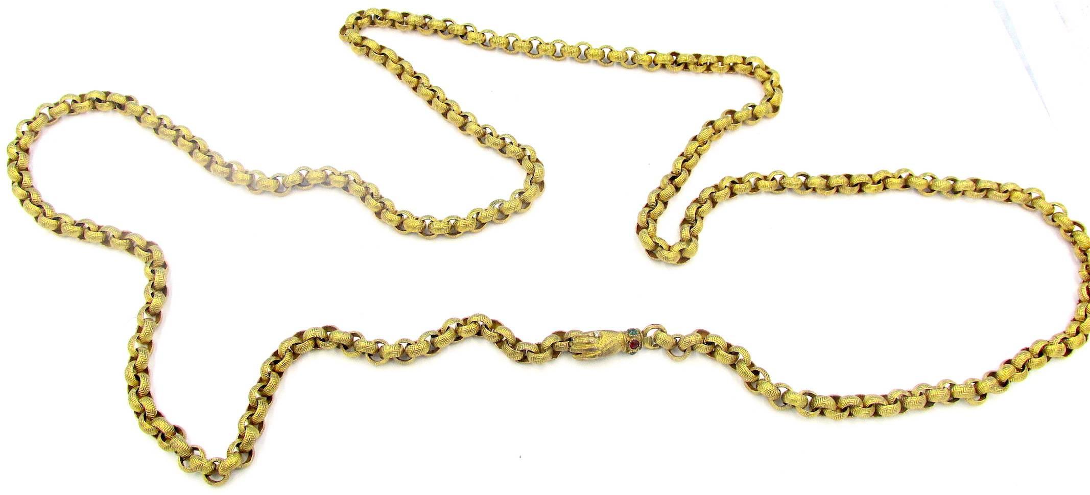 Fabulous Georgian Pinchbeck muff chain with a hand clasp set with colored paste stones. Christopher Pinchbeck developed an alloy of copper and zinc in 1720 that had the look of real gold and did not tarnish. The jewelry made with this alloy survives