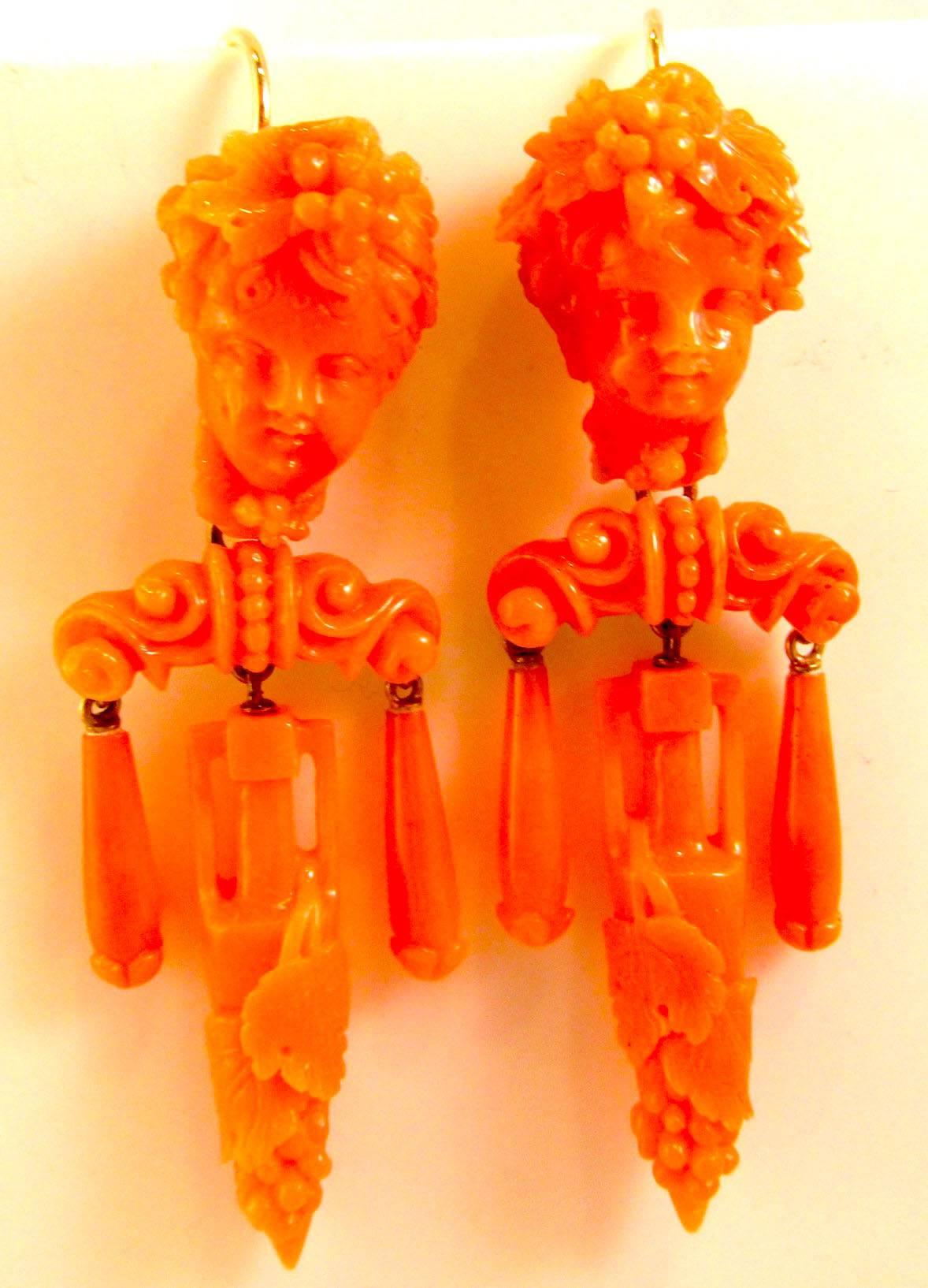 Victorian coral cameo earrings with girandole drops, the longest having a grape motif, set in 15K gold. The cameos are of cherubs with grape vines in their hair. The wonderful deep coral color will enhance any wardrobe. The earrings measure 2 1/2