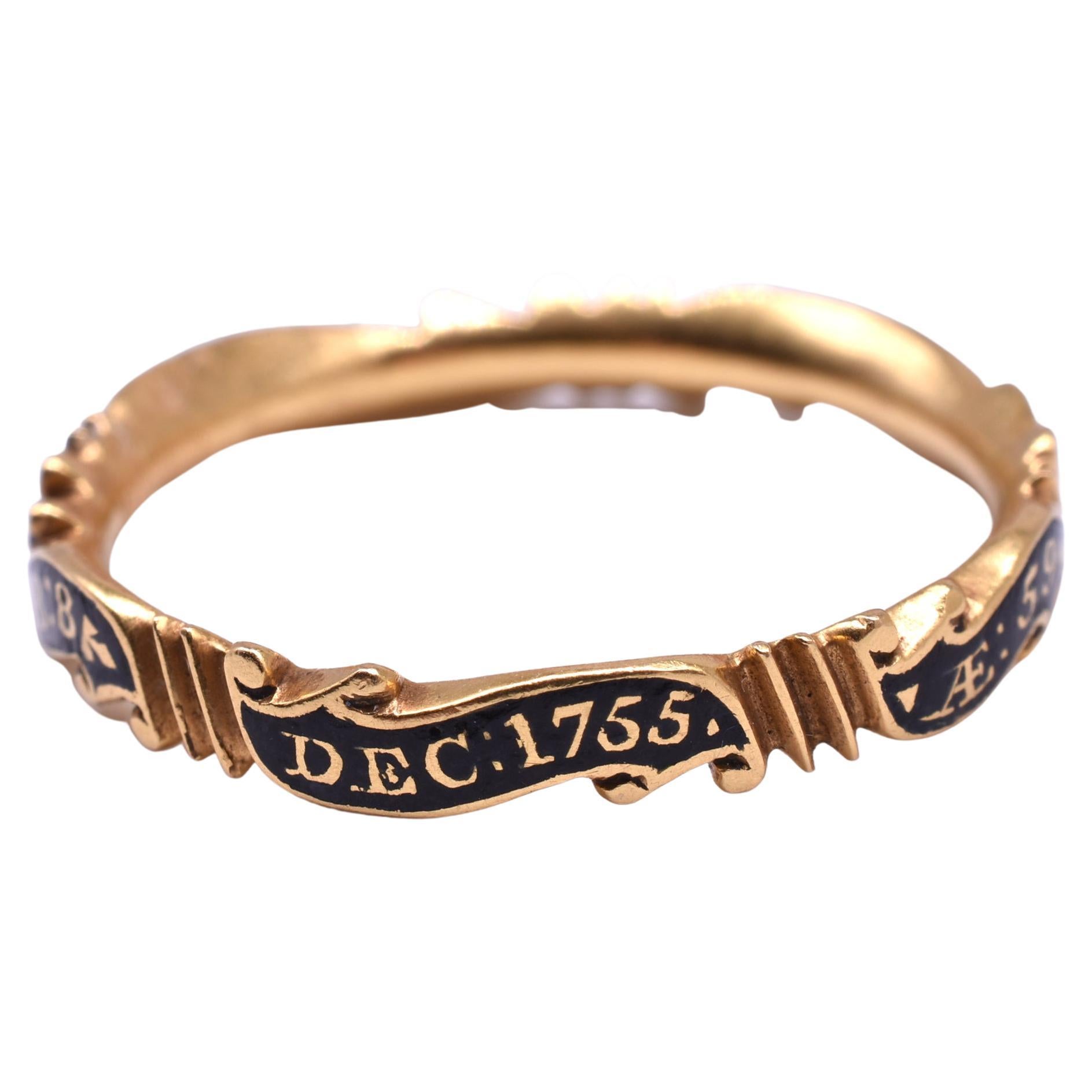 Romantic black enameled wavy memorial band divided into scrolls with raised gold lettering for a Mrs. Martha Greswold. This is an excellent example of and 18th-century mourning ring and the wavy bands that emulate scrolls are the most rare. The