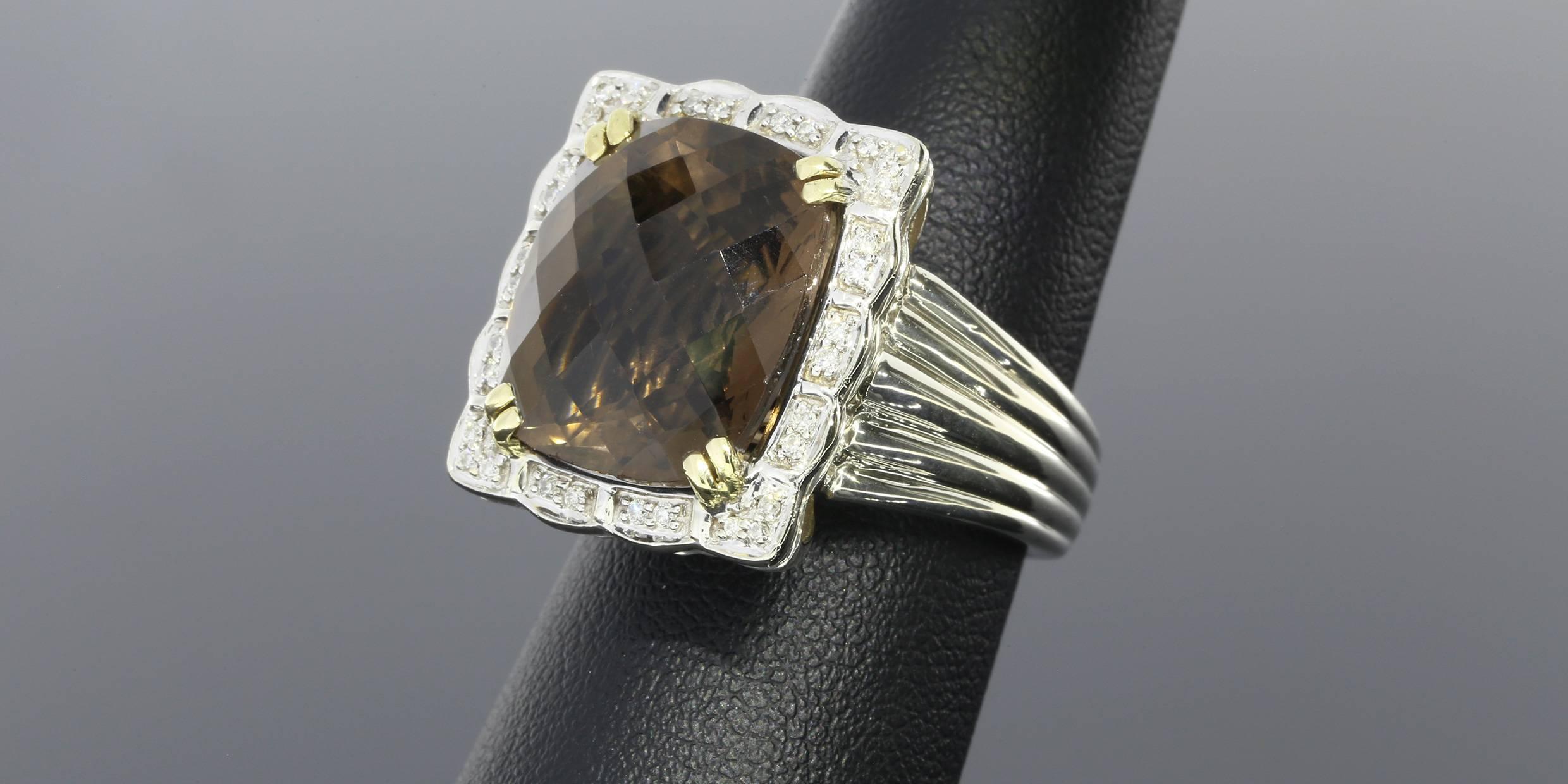 This stunning ring is part of the designer line Charles Krypell. The ring features a smoky quartz center stone as well as round brilliant cut diamonds weighing approximately 0.20CTW. The ring is comprised of sterling silver and 14 karat yellow gold.