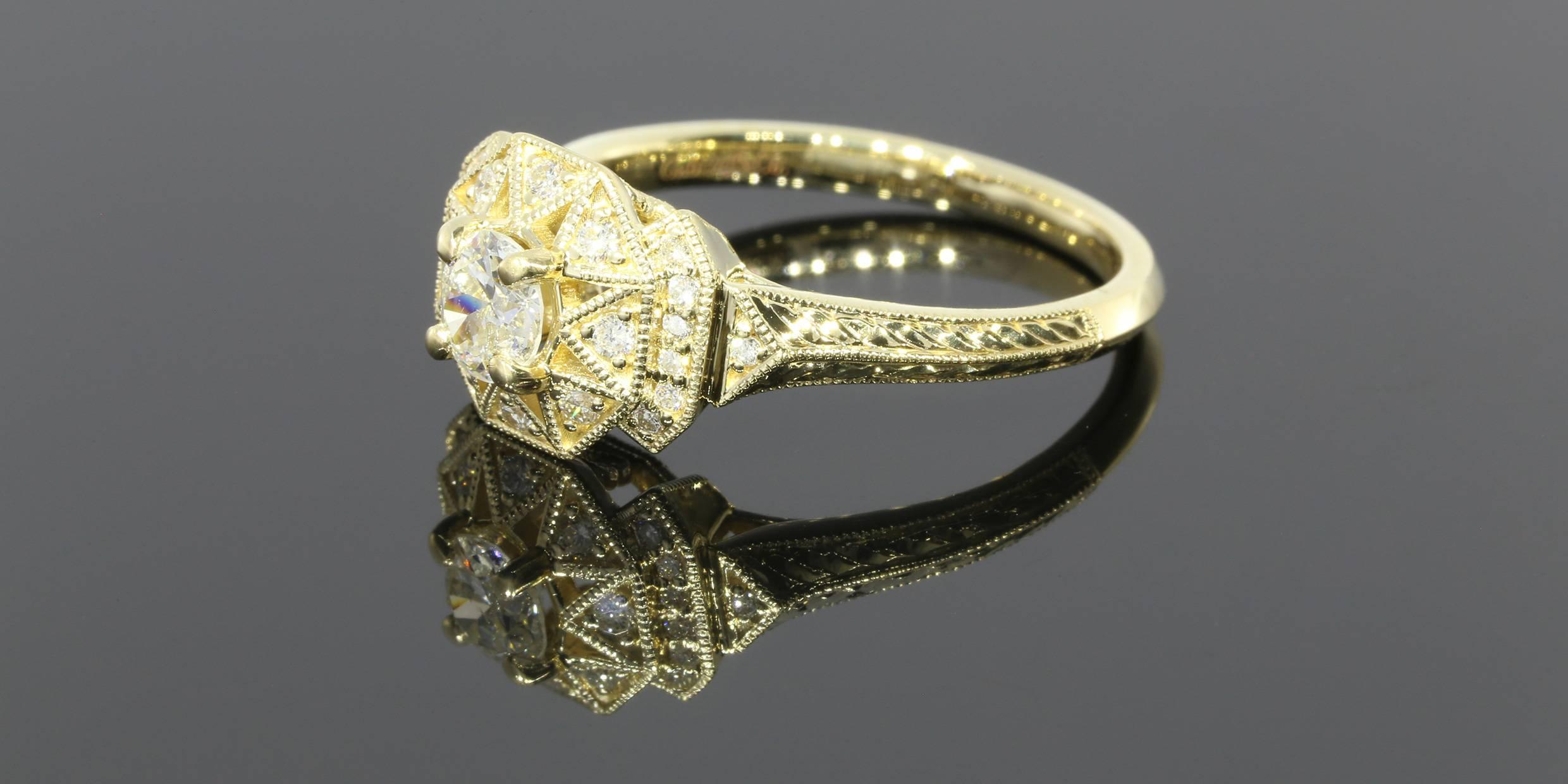 This engagement ring is Art Deco in design with geometric shapes and the yellow gold gives it an Aztec vibe. The Global Gemological Laboratories graded this diamond engagement ring and has given it an approximate total carat weight of .50CTW. The